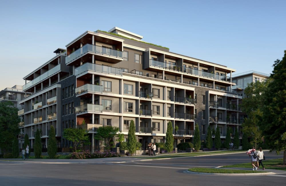 Slate & Ash – Angled street-level view of the mid-rise building's corner entrance with landscaped planters and pedestrians walking by.