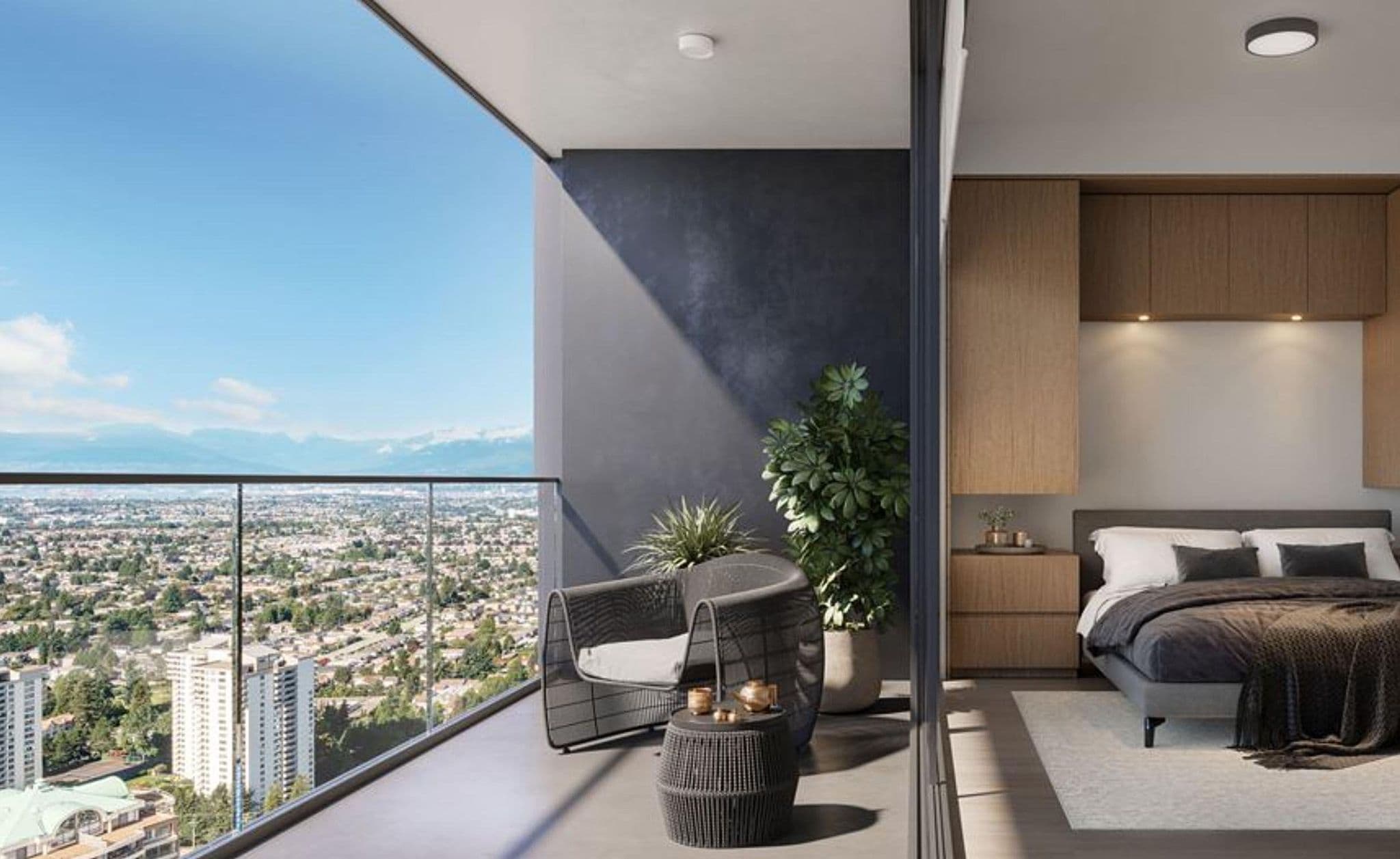 Central Park House – A modern bedroom opens onto a private covered balcony furnished with a woven lounge chair, side table, and potted plants. The glass balcony railing offers an expansive, high-angle view of a city landscape stretching toward distant mountain ranges under a clear blue sky.