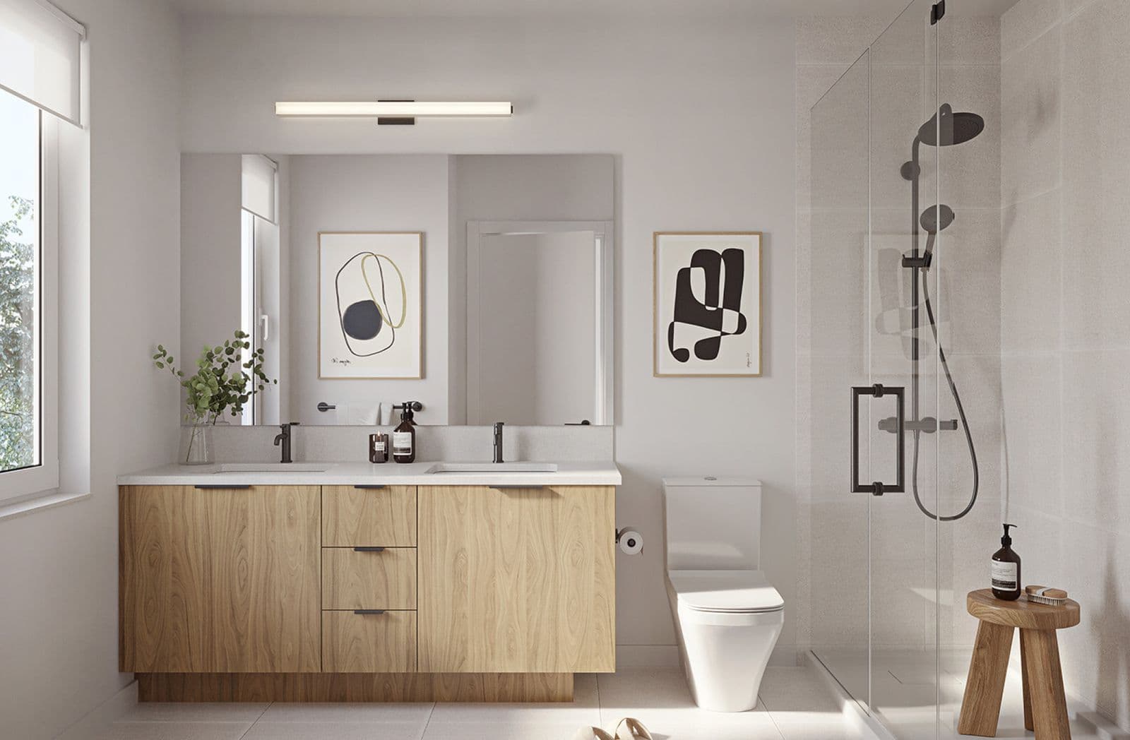 Dwell – Bathroom rendering, same design as the other unit bathroom, with wood double vanity, large mirror, framed art, and a glass shower with rain shower head.