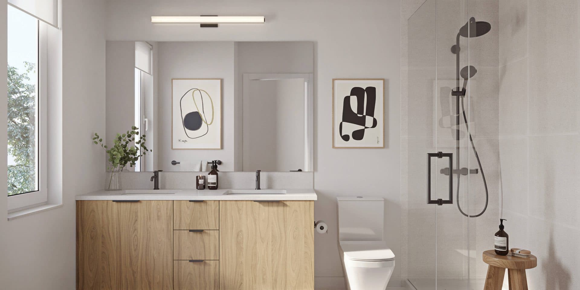 Dwell – Bathroom rendering with a wood double vanity, large mirror, framed abstract art, toilet, and a glass-enclosed shower with a wood stool inside.