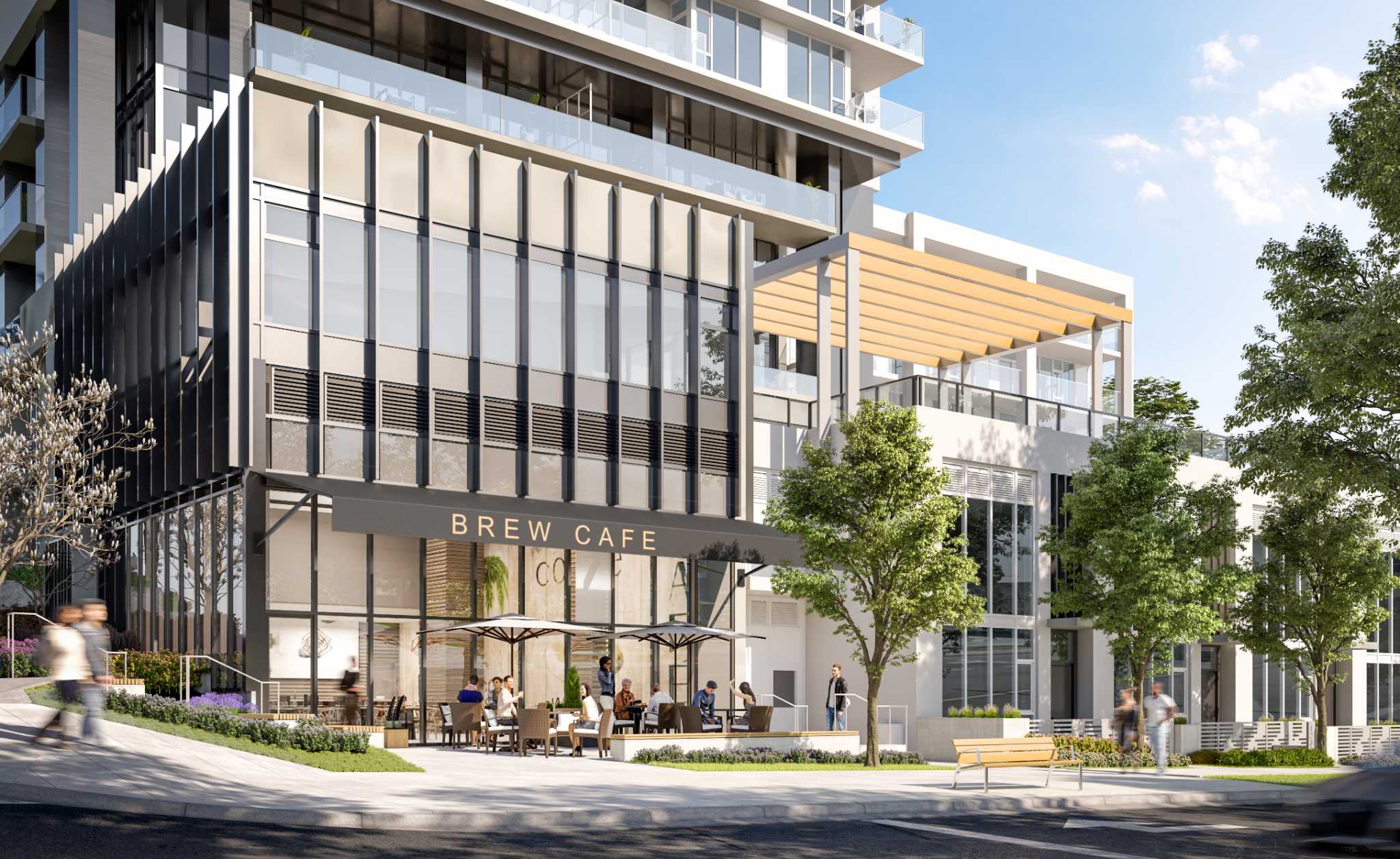 Vue – A street-level view of a contemporary mixed-use residential building featuring 'BREW CAFE' with outdoor patio seating and umbrellas. Pedestrians walk along the sloping, tree-lined sidewalk under bright daytime sunlight beside modern glass facades, vertical louvers, and a wooden pergola terrace above.