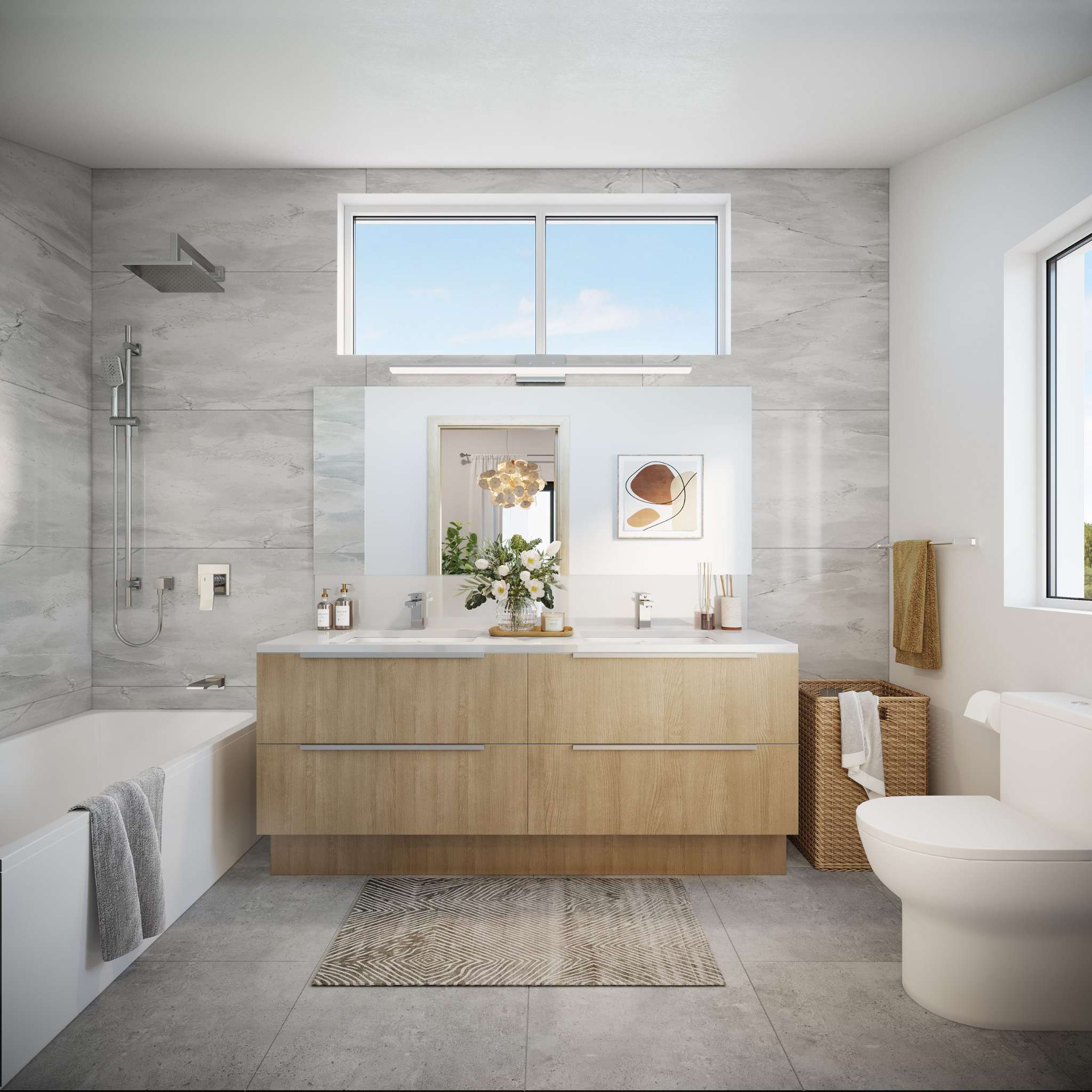 West58 – A bright, modern bathroom featuring a double vanity with light natural wood cabinetry, a white soaking tub with polished chrome shower fixtures, and light grey marble-patterned wall tiles. Natural daylight pours in from a high horizontal window set above a wide frameless mirror, complemented by a wicker laundry basket and minimalist decor.