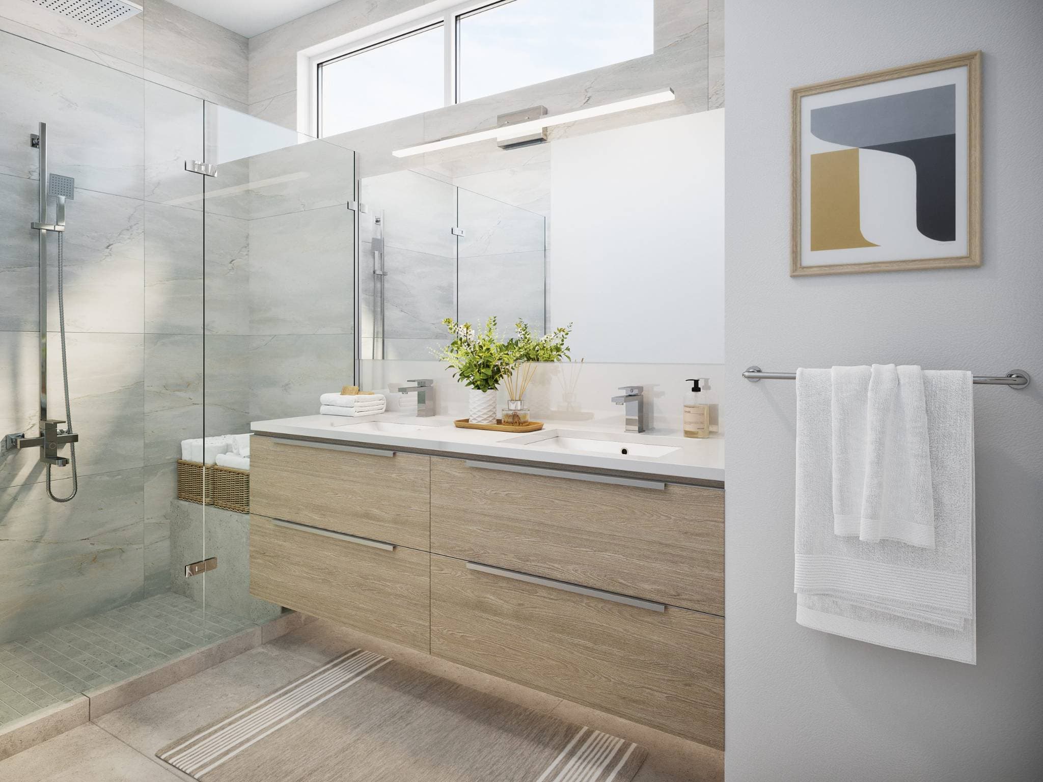 West58 – A bright, modern bathroom featuring a floating light-wood double vanity with white countertops, chrome fixtures, and a large frameless mirror. Adjacent is a walk-in glass shower lined with soft gray stone tiles, illuminated by natural light from high clerestory windows.