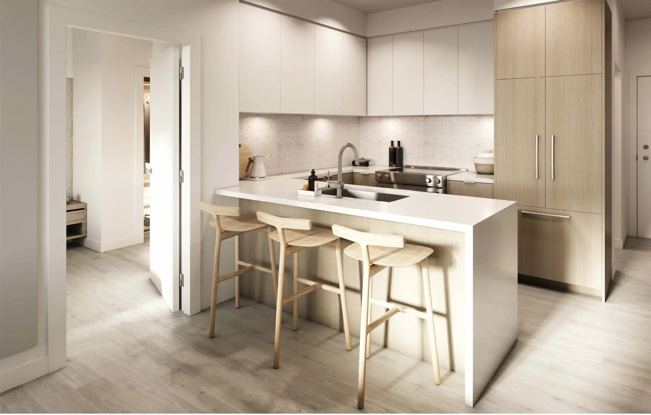 Rove – Kitchen with white cabinetry, wood-toned island with waterfall countertop, and stainless appliances including a built-in refrigerator.