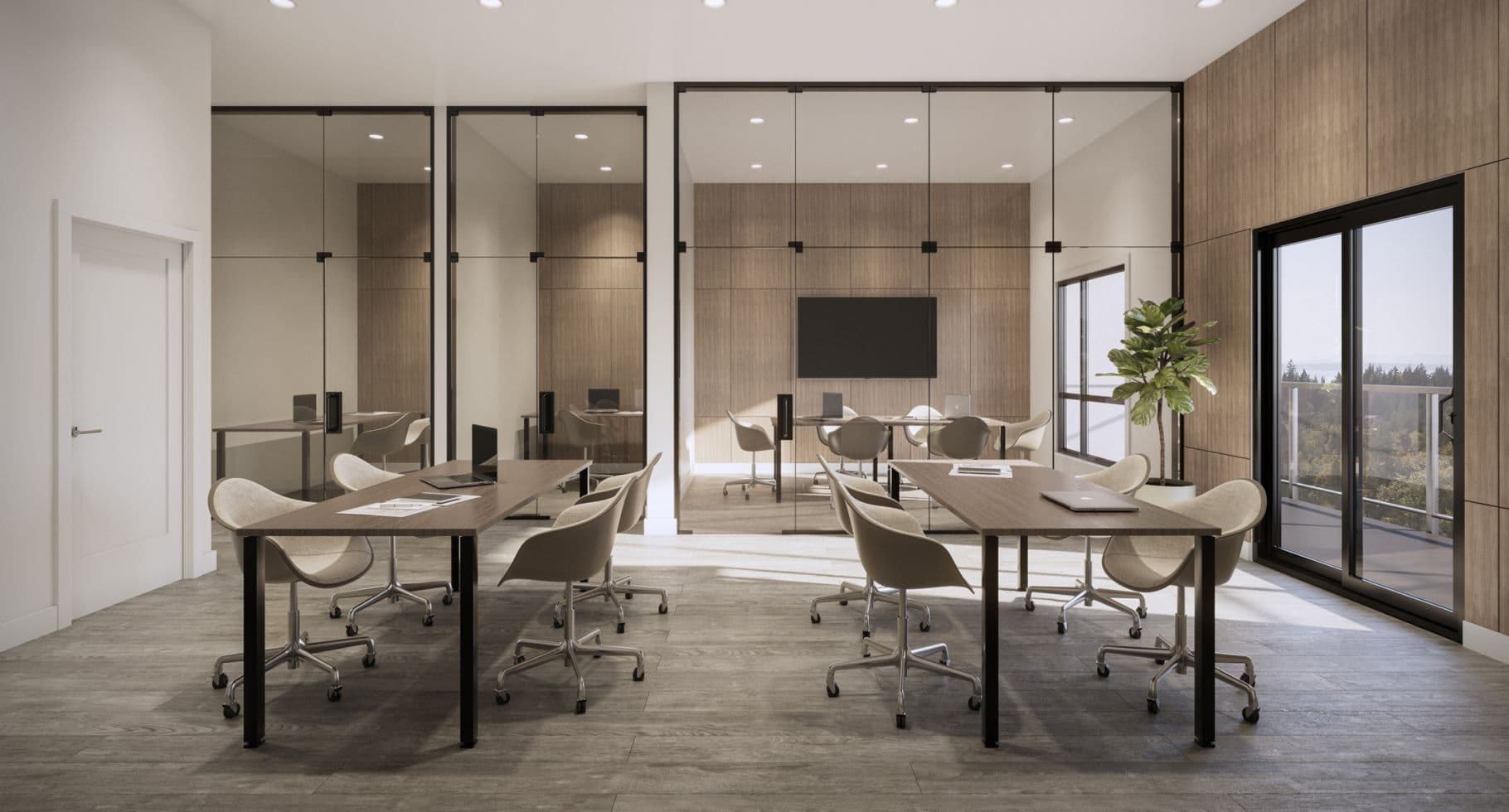 Amson Bloc – A modern co-working and meeting space featuring shared wooden conference tables with office chairs in the foreground and glass-enclosed private offices and conference rooms in the background. Natural light pours in from a sliding glass door on the right that opens to a balcony overlooking lush green treetops.
