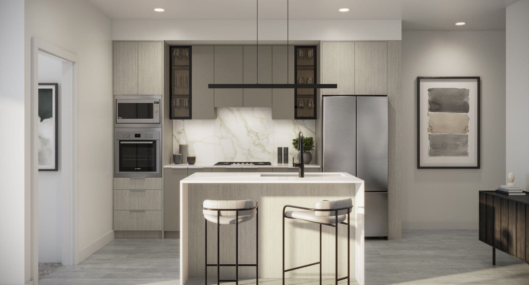 Amson Bloc – A modern, open-concept kitchen featuring light wood cabinetry, integrated stainless steel appliances, and a marble-patterned backsplash. A waterfall island with a sink and two contemporary barstools is centered beneath a sleek black linear pendant light, softly lit by daylight.