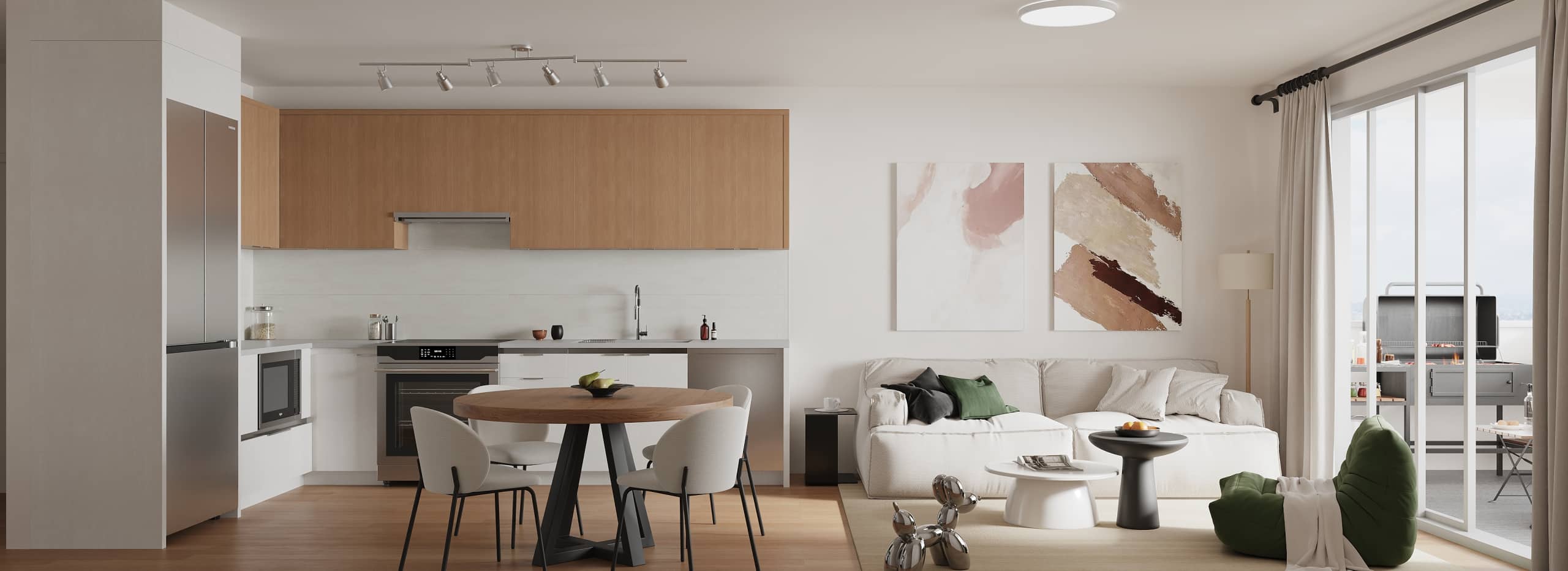 Terra Garden – A bright, modern open-concept apartment interior featuring a streamlined kitchen with light wood upper cabinets and stainless steel appliances, seamlessly connected to a round dining table and a cozy living room. Large sliding glass doors flood the space with natural daylight and open onto an outdoor balcony with a barbecue grill.