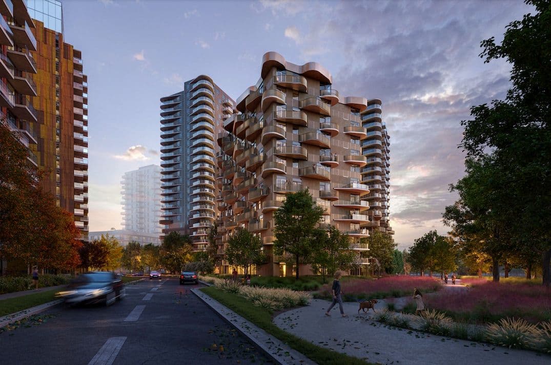New Village – A cluster of high-rise towers including a distinctively curved-balcony tower, photographed from a street-level park pathway at dusk with people walking dogs.