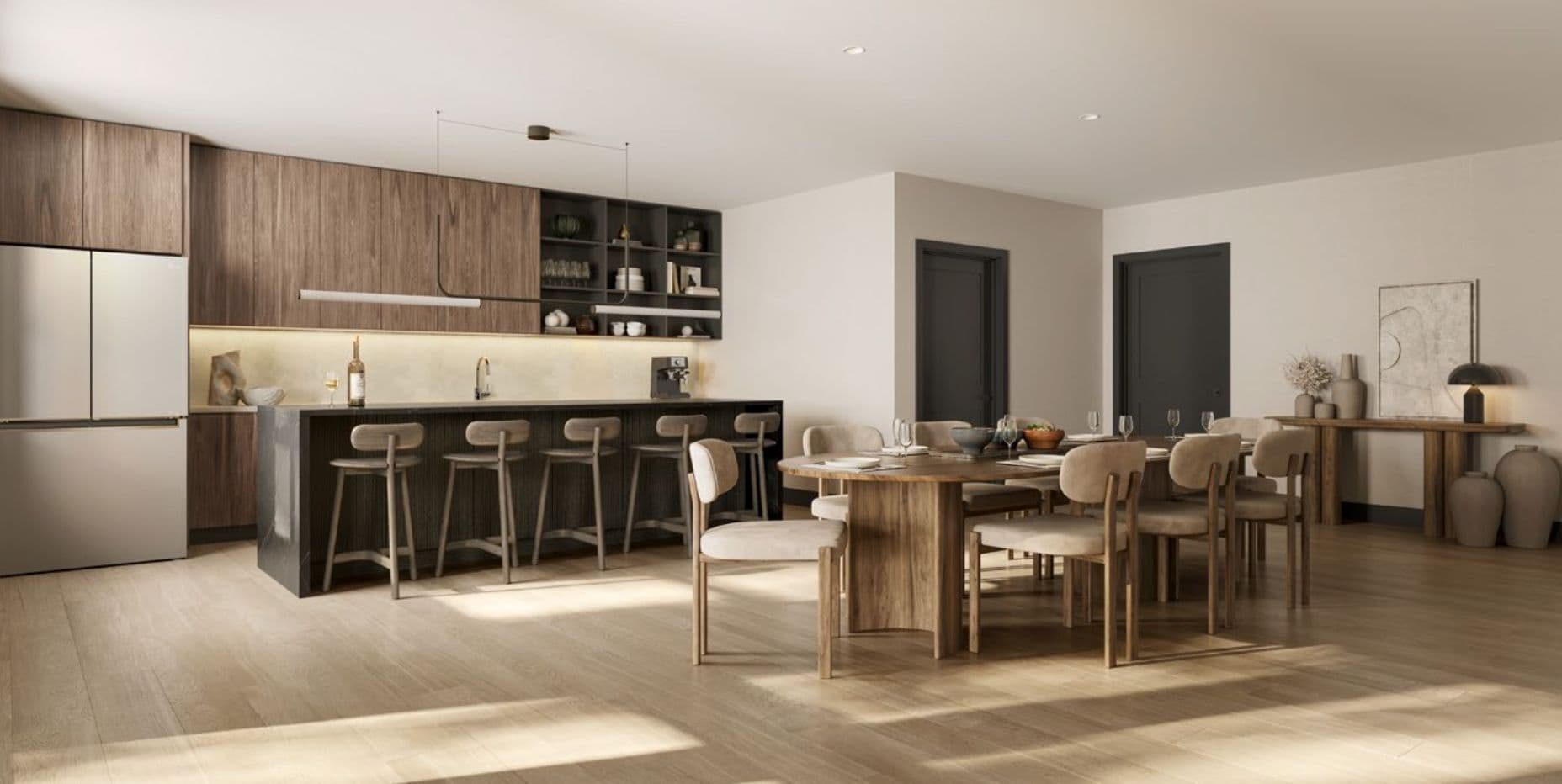 The Merchant – Shared social kitchen and dining lounge with dark wood cabinetry, bar stools along an island, and a long dining table with upholstered chairs.