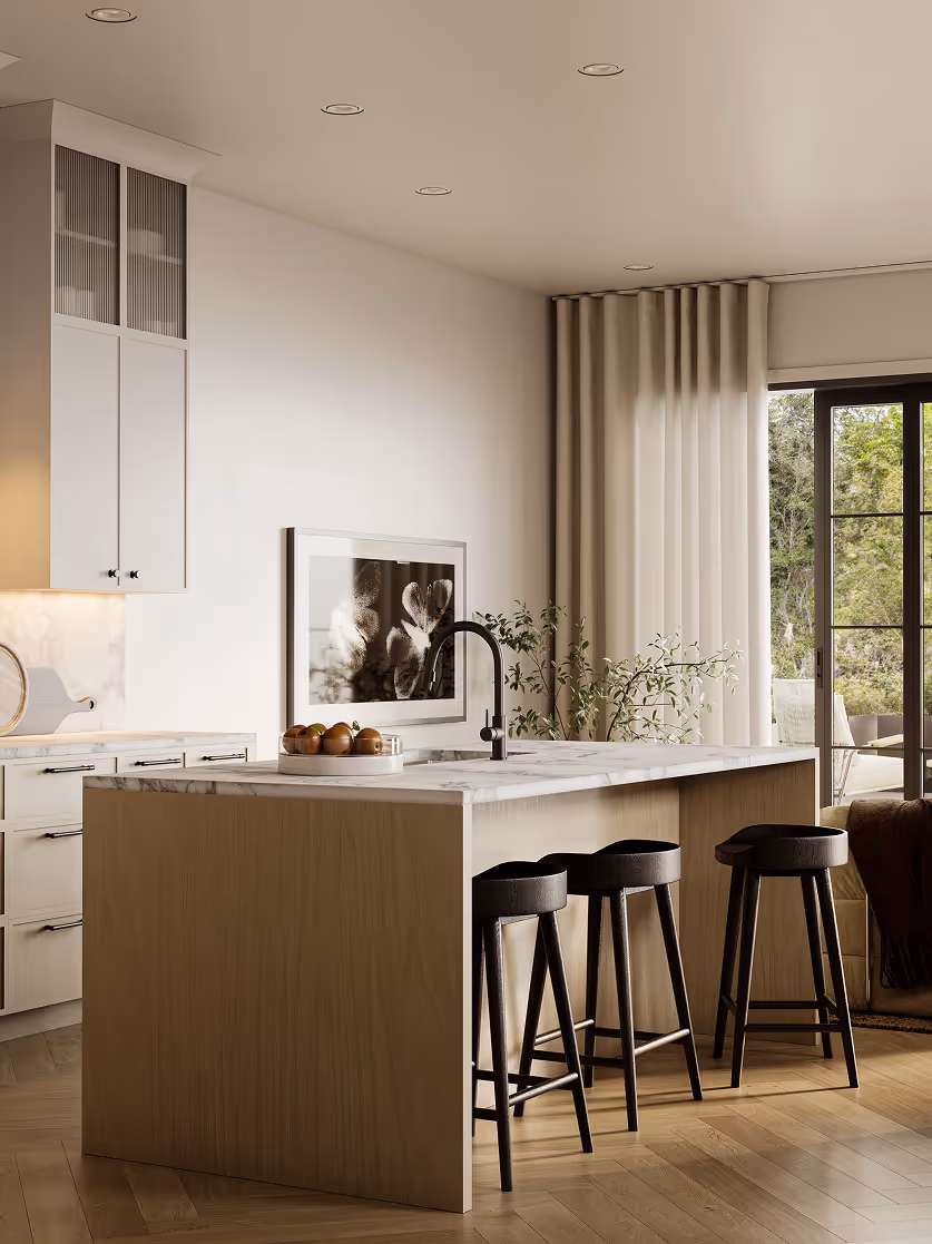 Wallace – A modern, sunlit kitchen featuring a light wood island with a white marble countertop, a matte black faucet, and three contemporary black barstools. In the background, cream-toned cabinetry with reeded glass upper accents complements hardwood floors and a sliding glass door draped in sheer curtains leading to an outdoor terrace.
