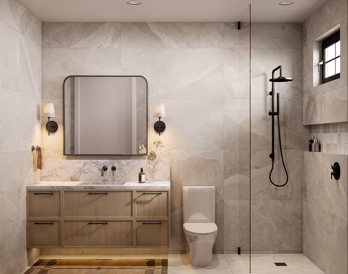 Wallace – A modern bathroom features light stone wall tiles, a floating light-wood vanity with marble countertop, and matte black fixtures. A glass partition separates a walk-in shower with black hardware, accented by soft wall sconce lighting beside a large rounded-corner mirror.