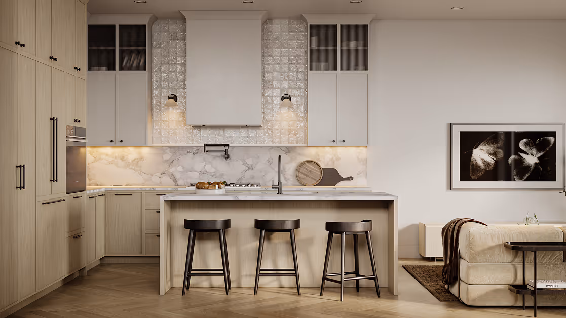 Wallace – A bright, upscale kitchen features pale wood flat-panel cabinetry, herringbone hardwood flooring, and a marble waterfall island with three black counter stools. The cooking area is framed by textured white wall tiles, integrated wall sconces, a marble backsplash, and upper cabinets with fluted glass doors, transitioning into an open-concept living space.