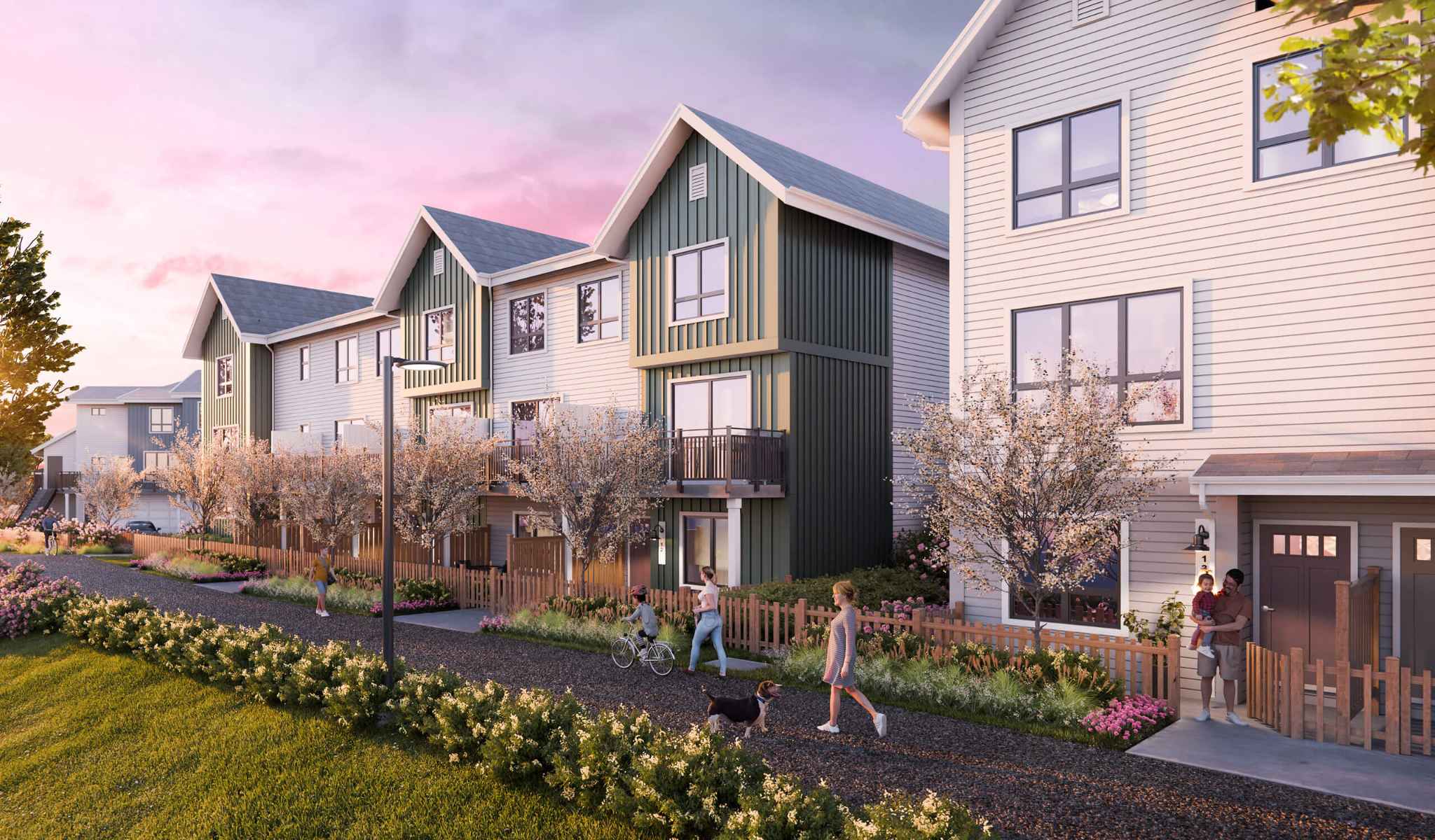 Mercer Village – Rendering of townhomes at dusk with green and white siding, second-floor balconies, and a family with a child and dog walking along a garden path.