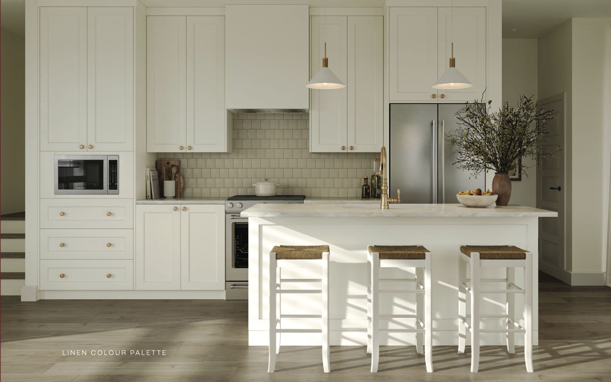 Renfrew South – Kitchen in a cream 'linen colour palette' with shaker cabinets, brass hardware and pendant lights, a subway tile backsplash, and an island with bar stools.