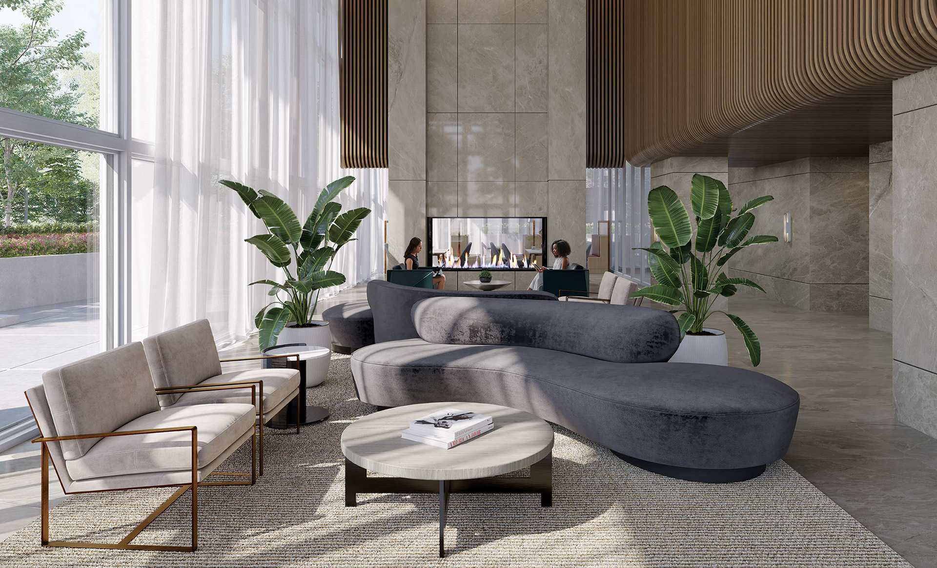 Smith & Farrow – A lobby lounge with curved grey velvet sofas, armchairs, and a marble fireplace where two people are seated talking.