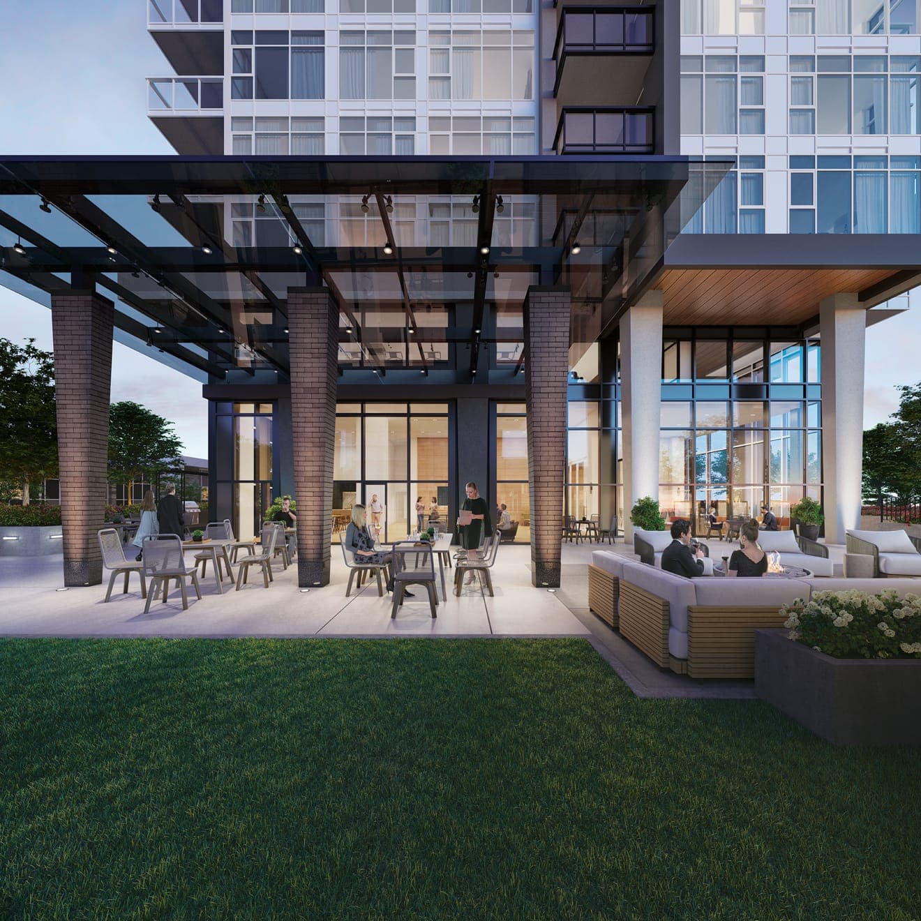 Smith & Farrow – An outdoor covered patio lounge with people seated at tables and on sofas around a fire feature, with a grass lawn in front.