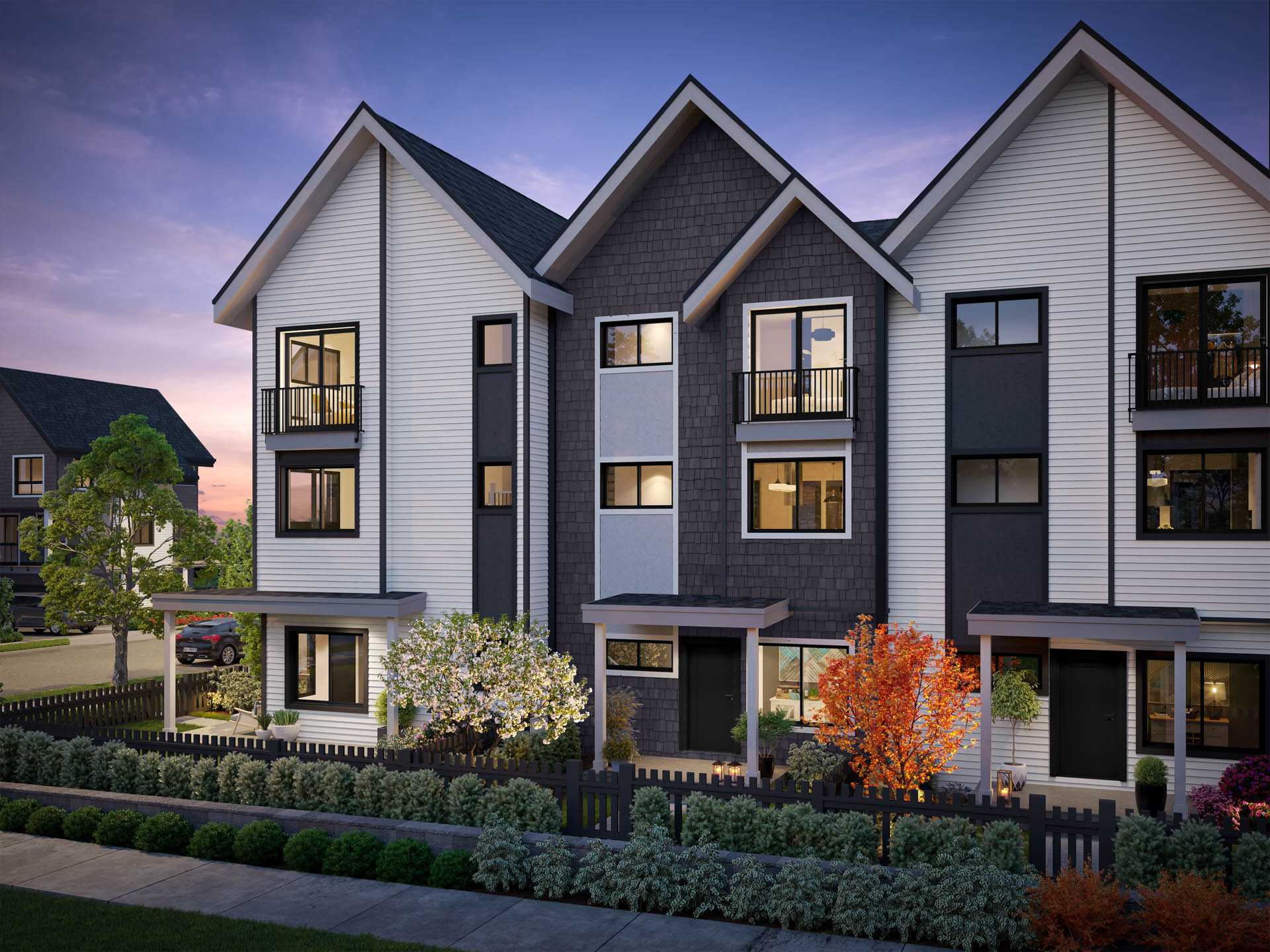Kin & Kith – Exterior rendering of modern three-story townhomes with gabled roofs, contrasting siding, front yards, and landscaping at dusk.