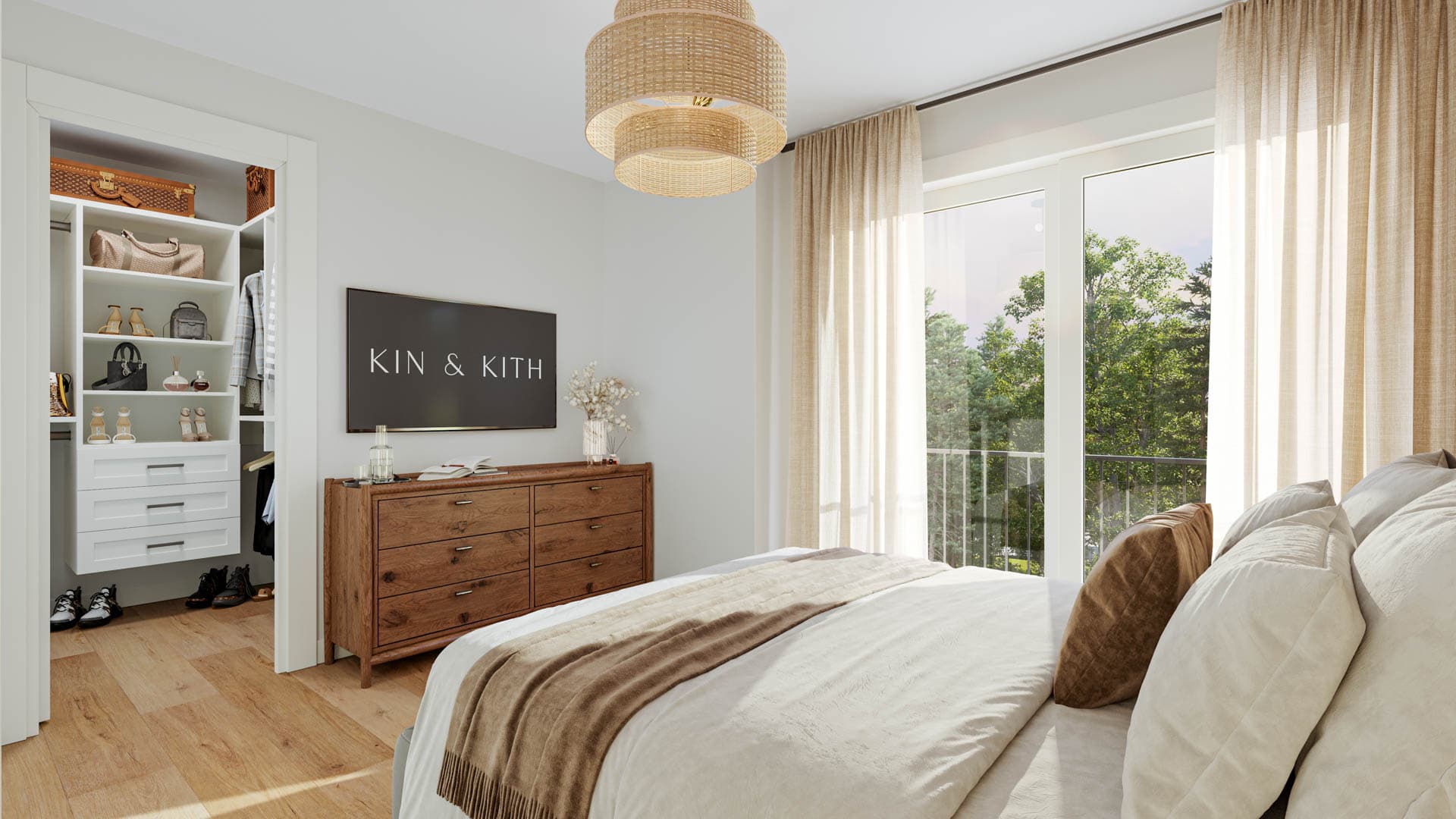 Kin & Kith – A bedroom view displaying the bed, wooden dresser under a wall-mounted TV, adjacent walk-in closet, and sliding patio doors.