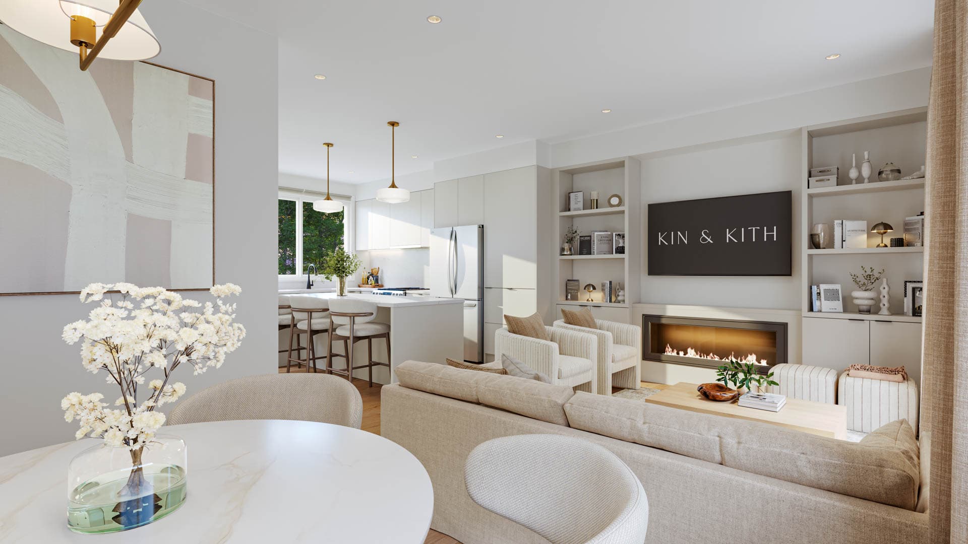Kin & Kith – Perspective showing the dining table in the foreground overlooking the main living room with fireplace and modern kitchen.
