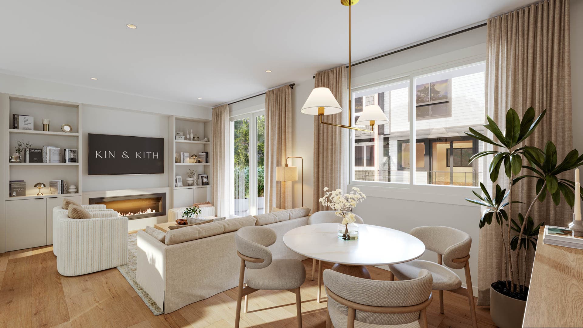 Kin & Kith – Modern dining area with a round table and upholstered chairs adjacent to the living room with fireplace and built-in shelving.