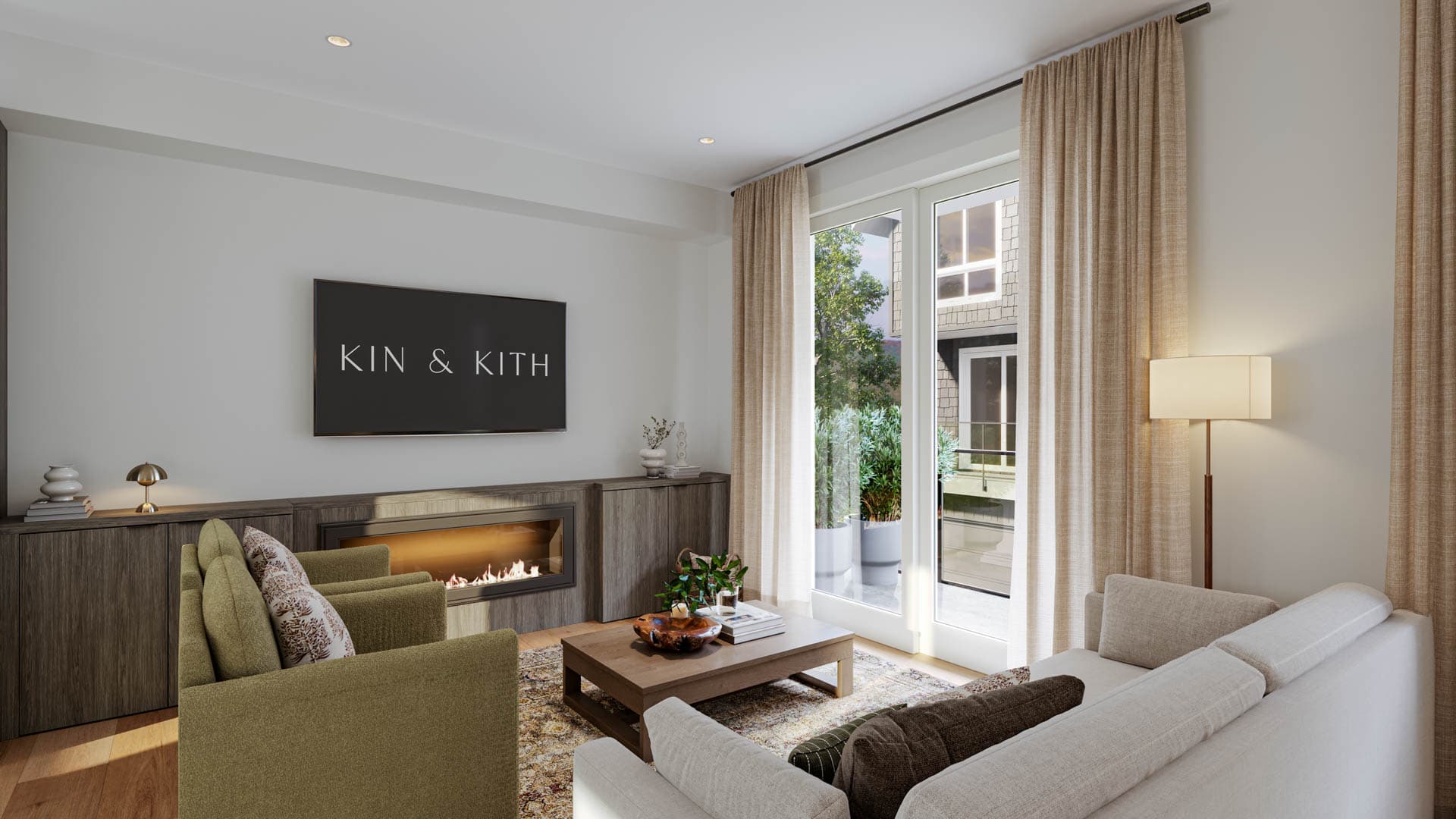 Kin & Kith – Living room featuring green armchairs, linear electric fireplace below a mounted screen, dark wood console cabinets, coffee table, and patio access.