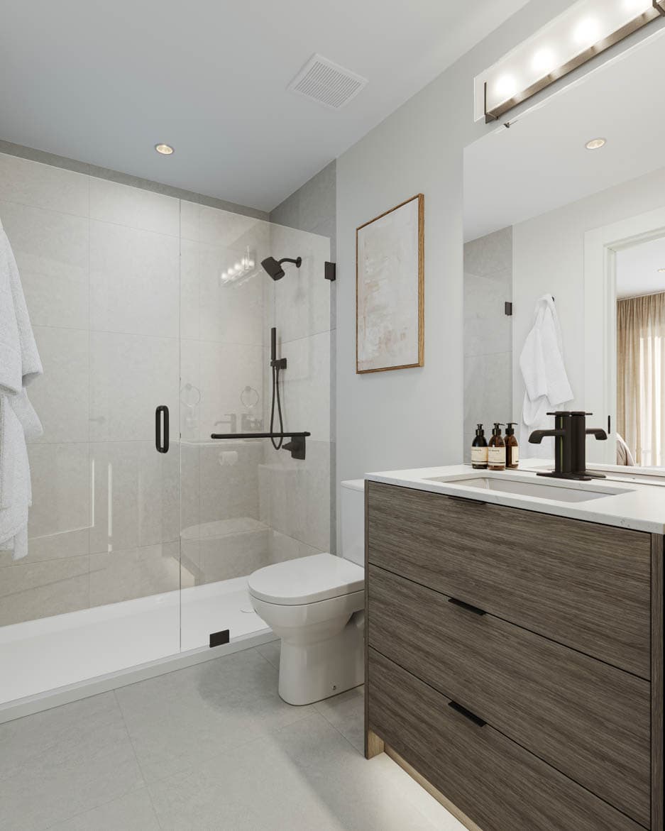 Kin & Kith – Bathroom featuring a frameless glass shower enclosure, dark textured wood vanity, toilet, and black faucet fixture.