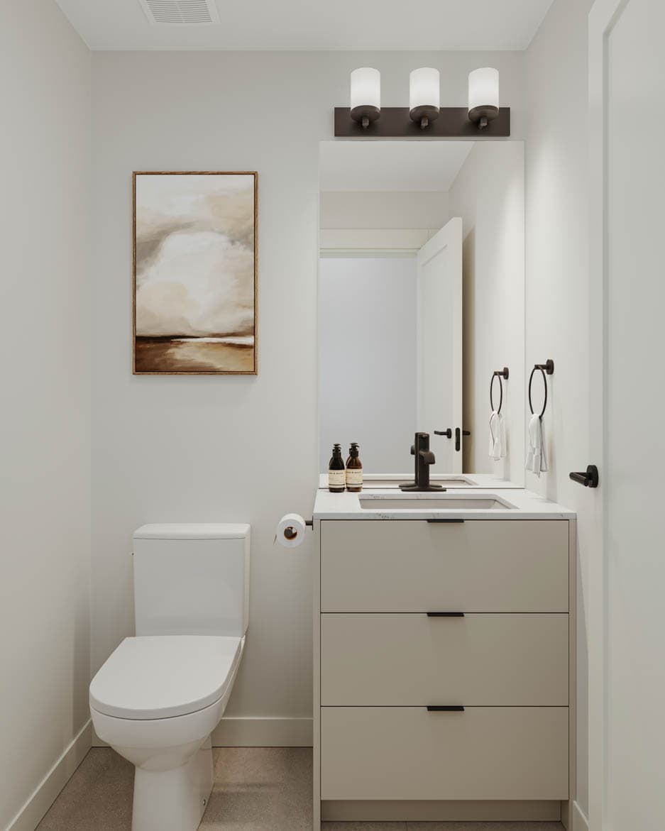 Kin & Kith – Powder room featuring an off-white vanity cabinet, black faucet and hardware, vanity light fixture, and framed wall art.