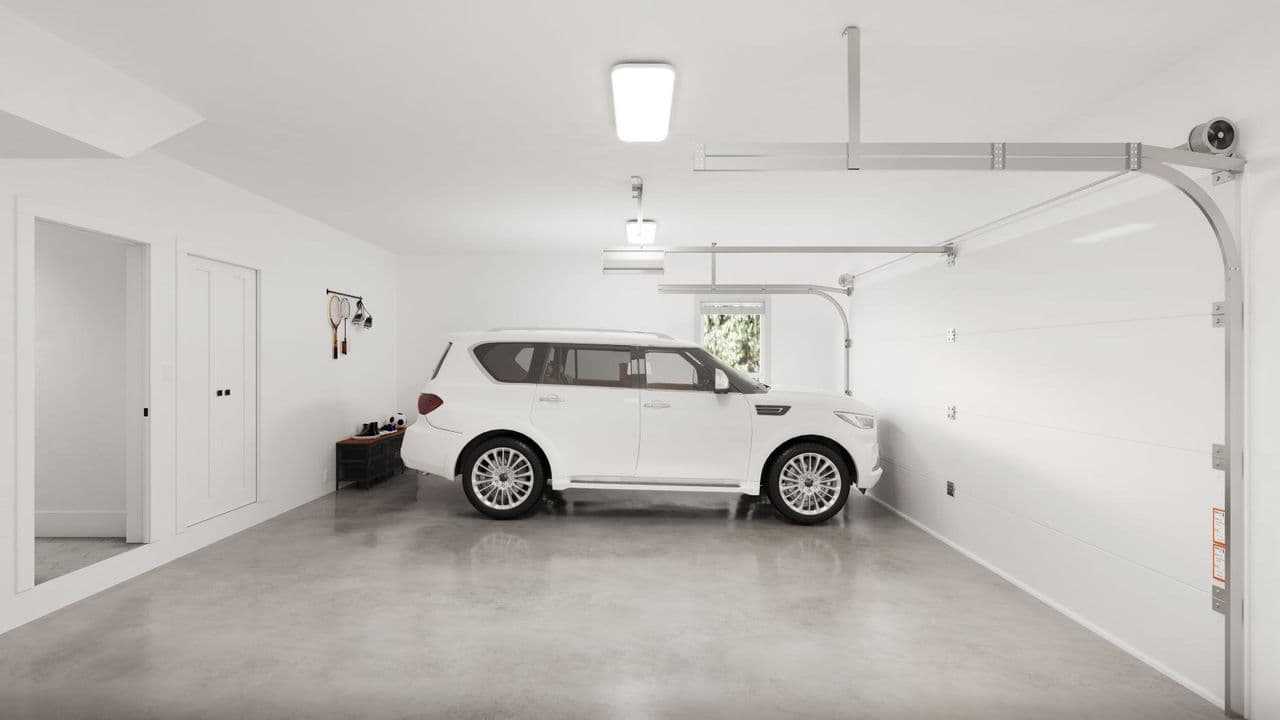 Jasper – Clean double-car garage with polished concrete flooring, white walls, and overhead automatic door tracks, with a white SUV parked inside near an interior doorway and a small bench with hooks for storage.