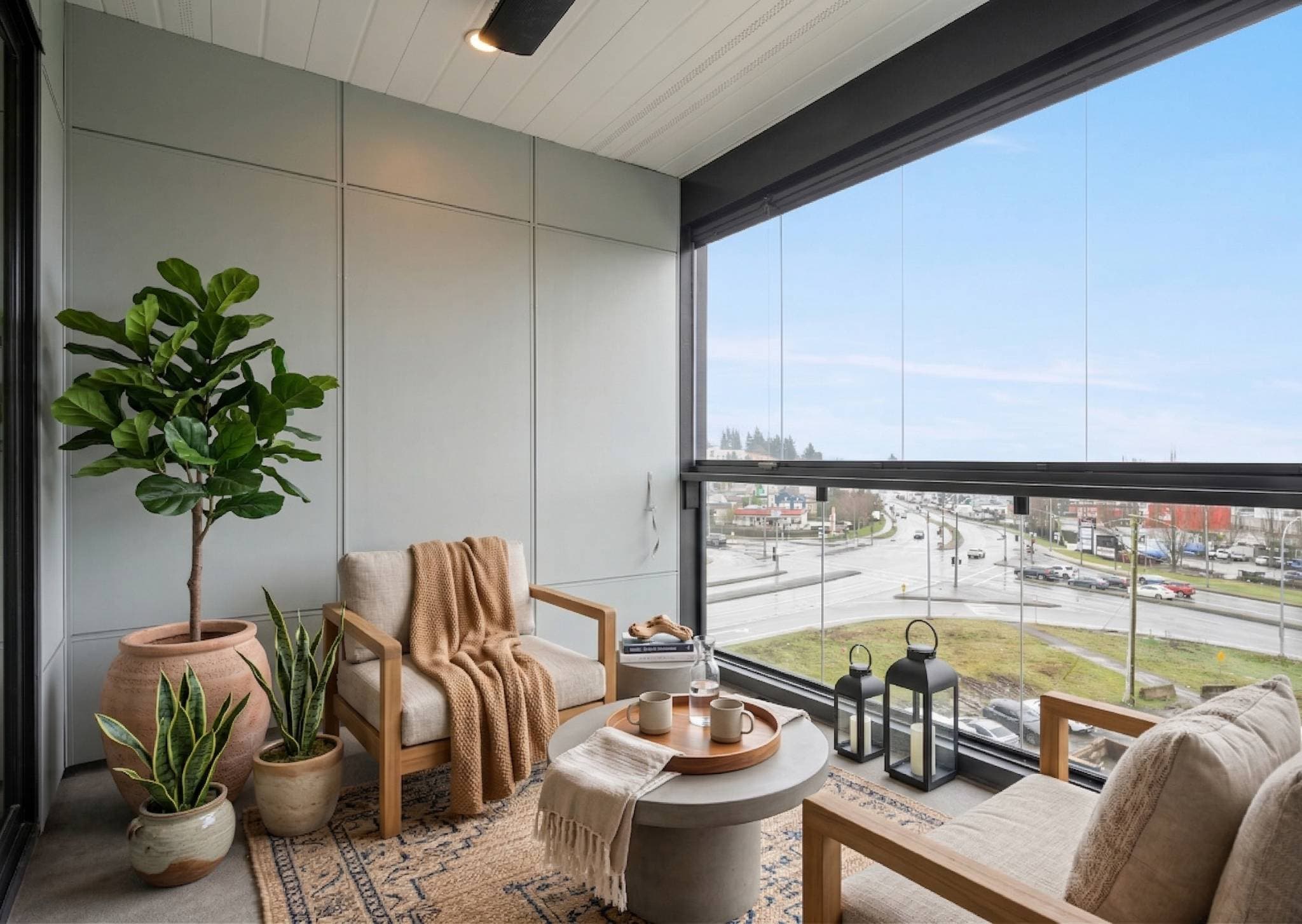Sage 3 – Building fitness room with dumbbell racks, a weight bench, treadmill, and large windows looking onto a courtyard where children play.