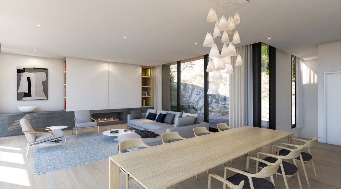 The Collection – Living and dining room rendering with a grey sectional sofa, fireplace, long wood dining table, and floor-to-ceiling windows facing a rocky hillside.