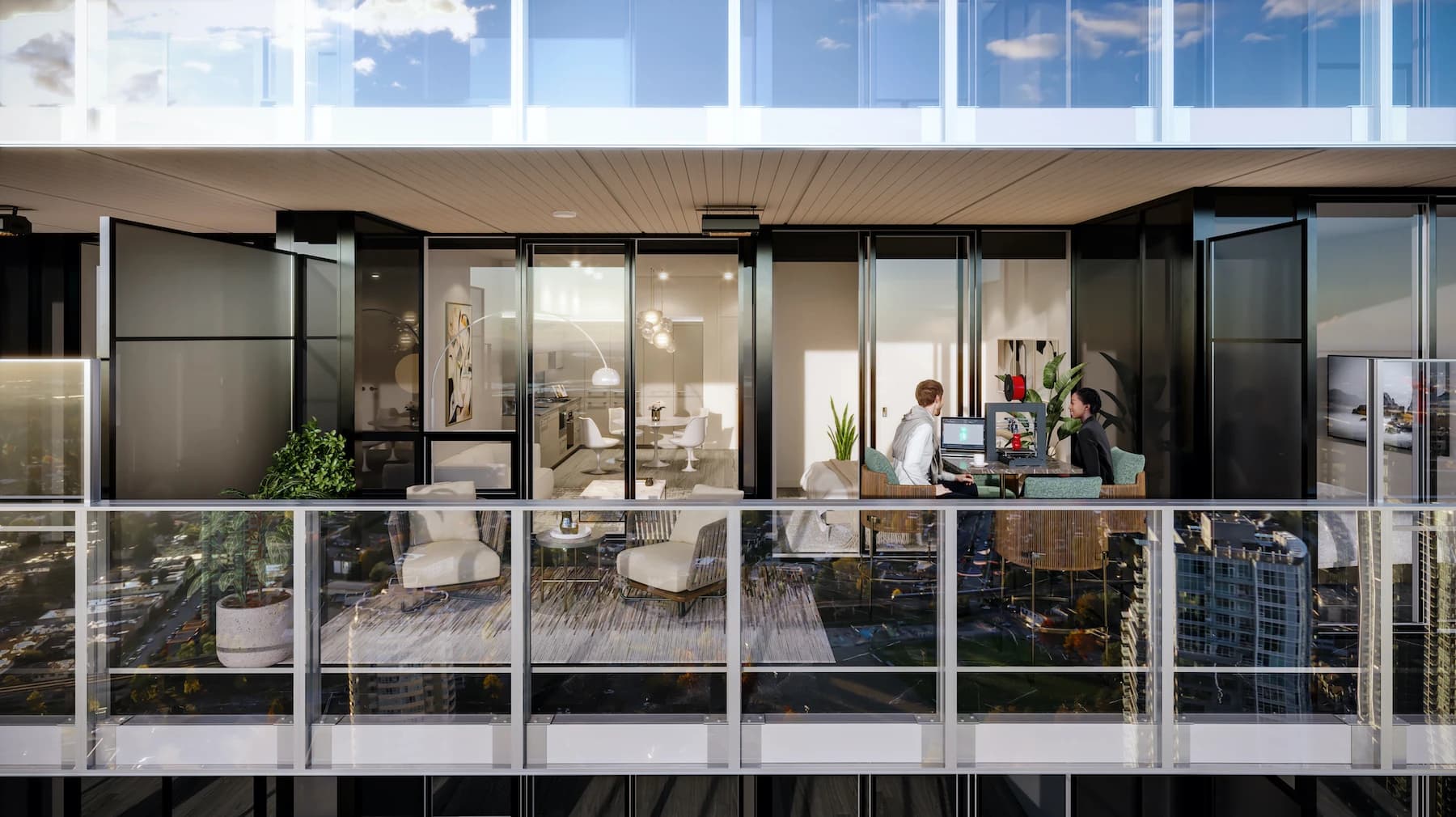 Concord Metrotown – An exterior view looking directly at a modern high-rise condo balcony with glass railings, outdoor seating, and potted plants. Sliding glass doors open into the brightly lit interior apartment where two people are seated at a table working, with the city reflected in the glass during bright daylight.