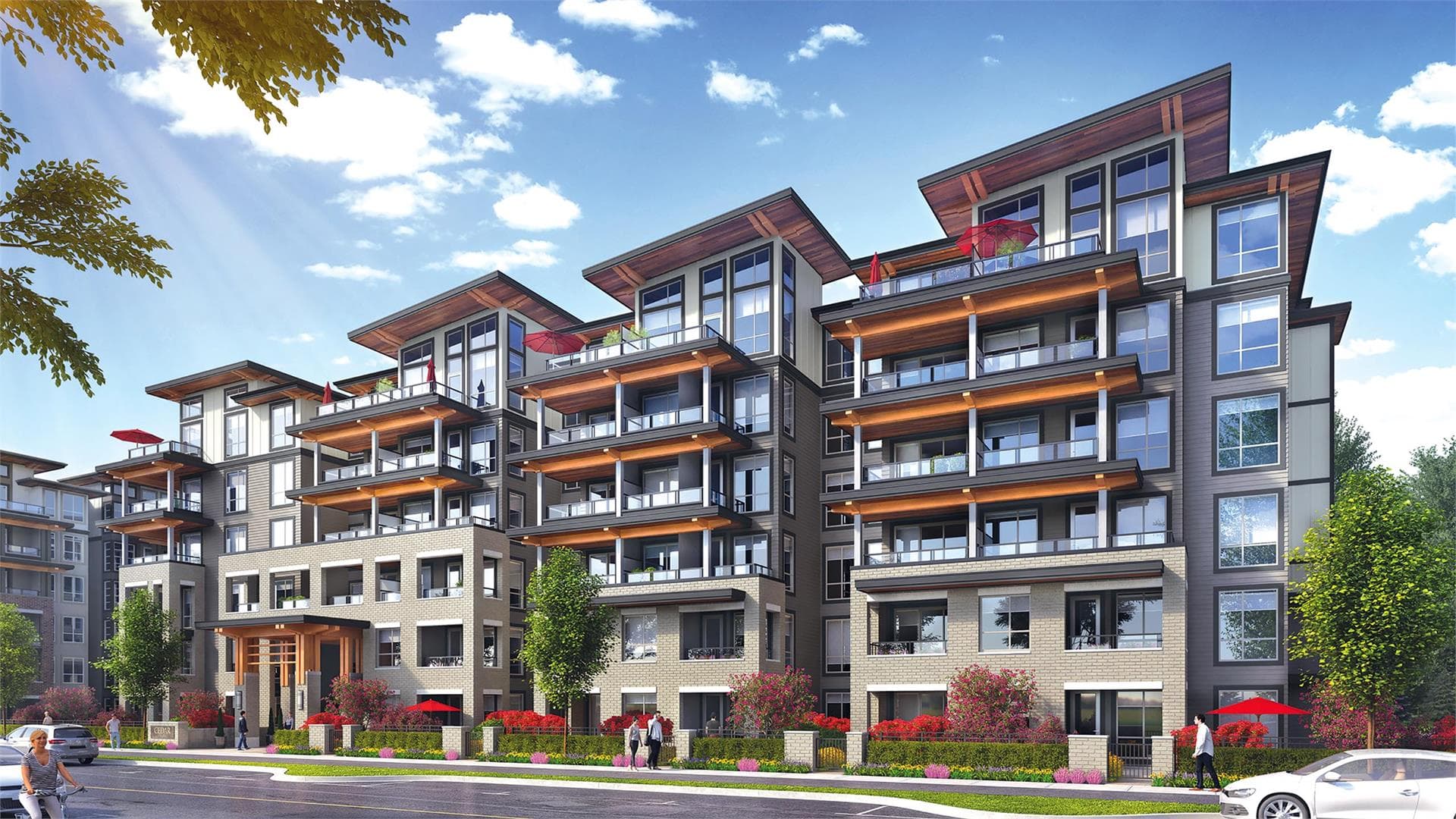 Cedar Creek (Signature Collection) Condos – Street-level view of a multi-story condo building with wood-clad shed roofs, red umbrellas on balconies, and a landscaped entrance with red flowering shrubs.