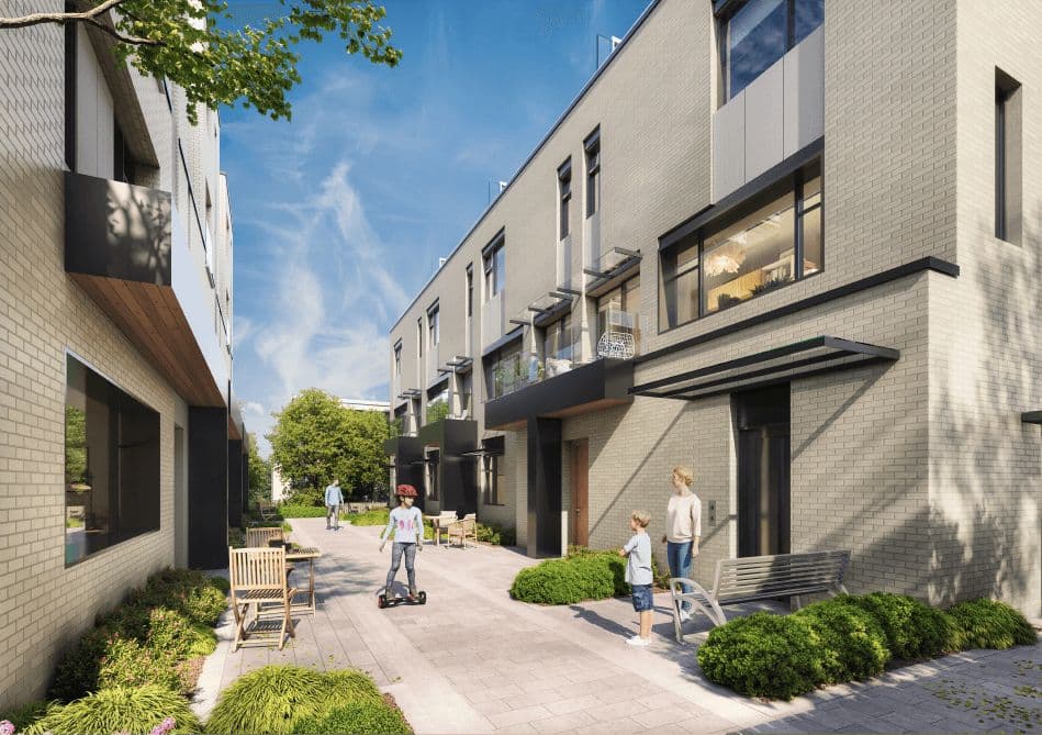 Terza – Courtyard walkway between townhome buildings with people, a scooter, and outdoor seating between the units.