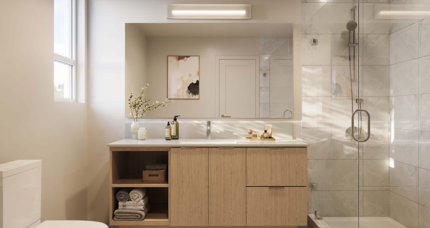 Ferndale Garden 4 – A bright, modern bathroom featuring a light wood vanity with open shelving, a large horizontal mirror, and a glass-enclosed walk-in shower with light gray marble tiling. Soft natural daylight pours in from a side window, creating a clean and serene ambiance.
