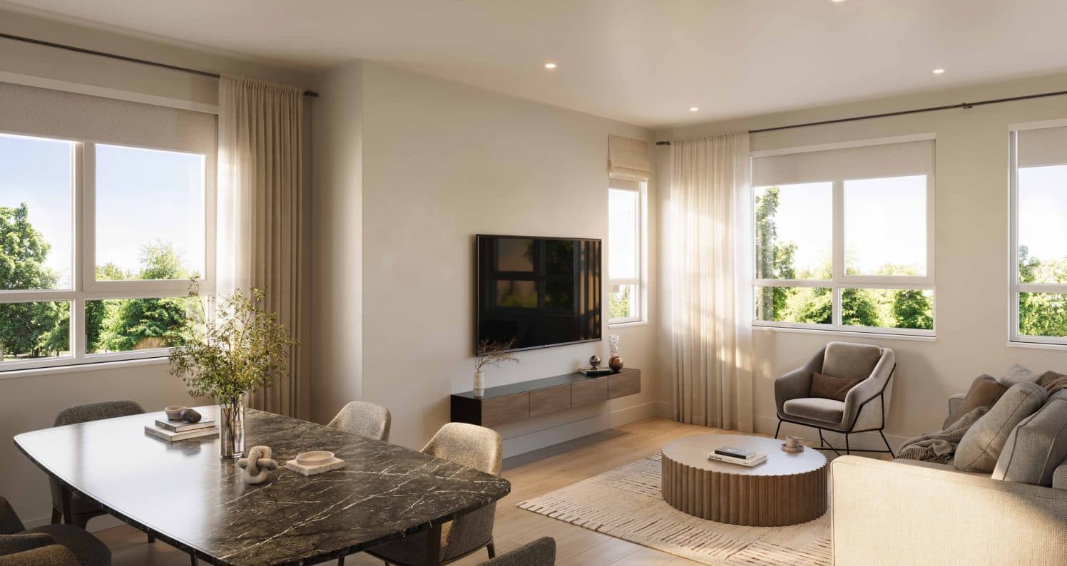 Ferndale Garden 4 – A bright, open-concept living and dining area features light neutral walls, wide-plank flooring, and large windows looking out onto lush green trees. Furnishings include a dark marble dining table, a fluted wood coffee table, an armchair, and a wall-mounted TV over a floating console.