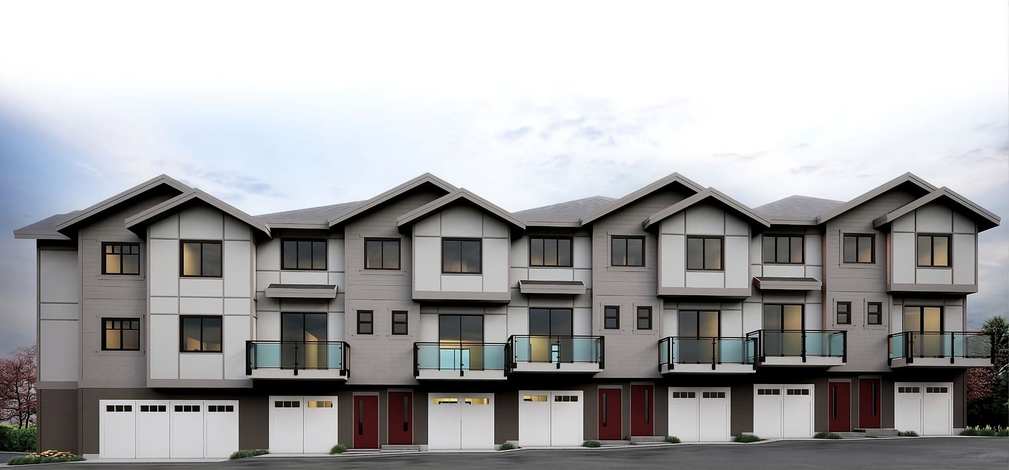 Mason Living – Full front elevation of a row of three-storey townhomes with gabled roofs, grey-and-white siding, glass balconies and private garages.
