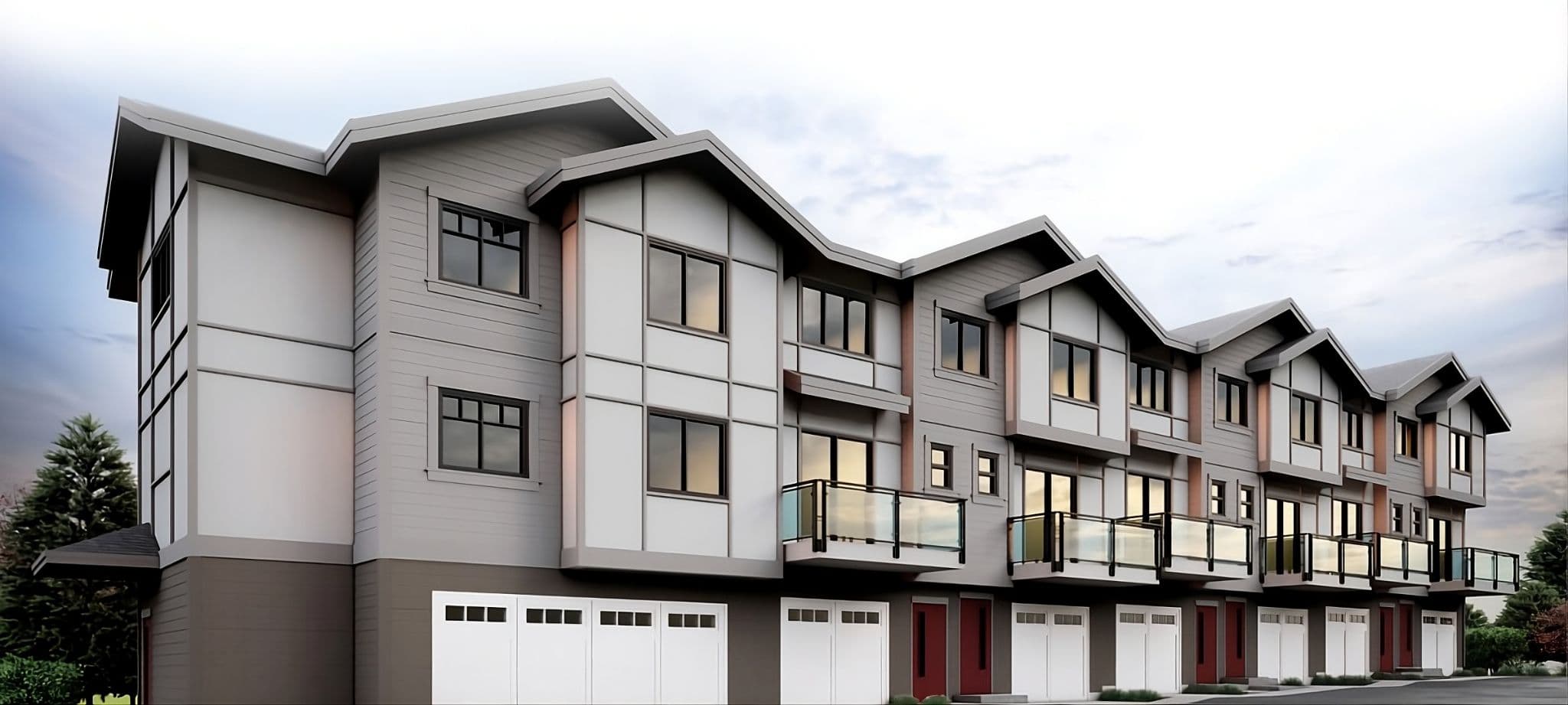 Mason Living – Three-quarter angled view of the three-storey woodframe townhouse building with gabled rooflines, glass balconies and ground-level garages.
