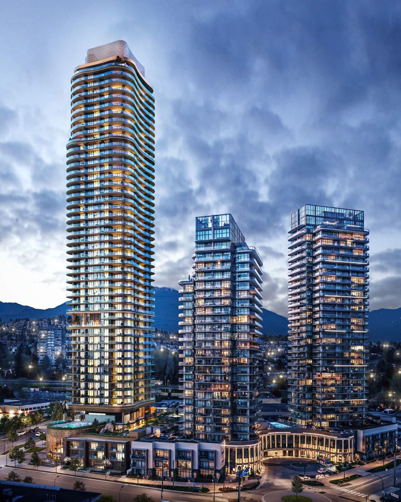 Étoile Gold Brentwood – Elevated dusk view of the tower alongside two neighboring towers, with mountains in the background and a roundabout street below.