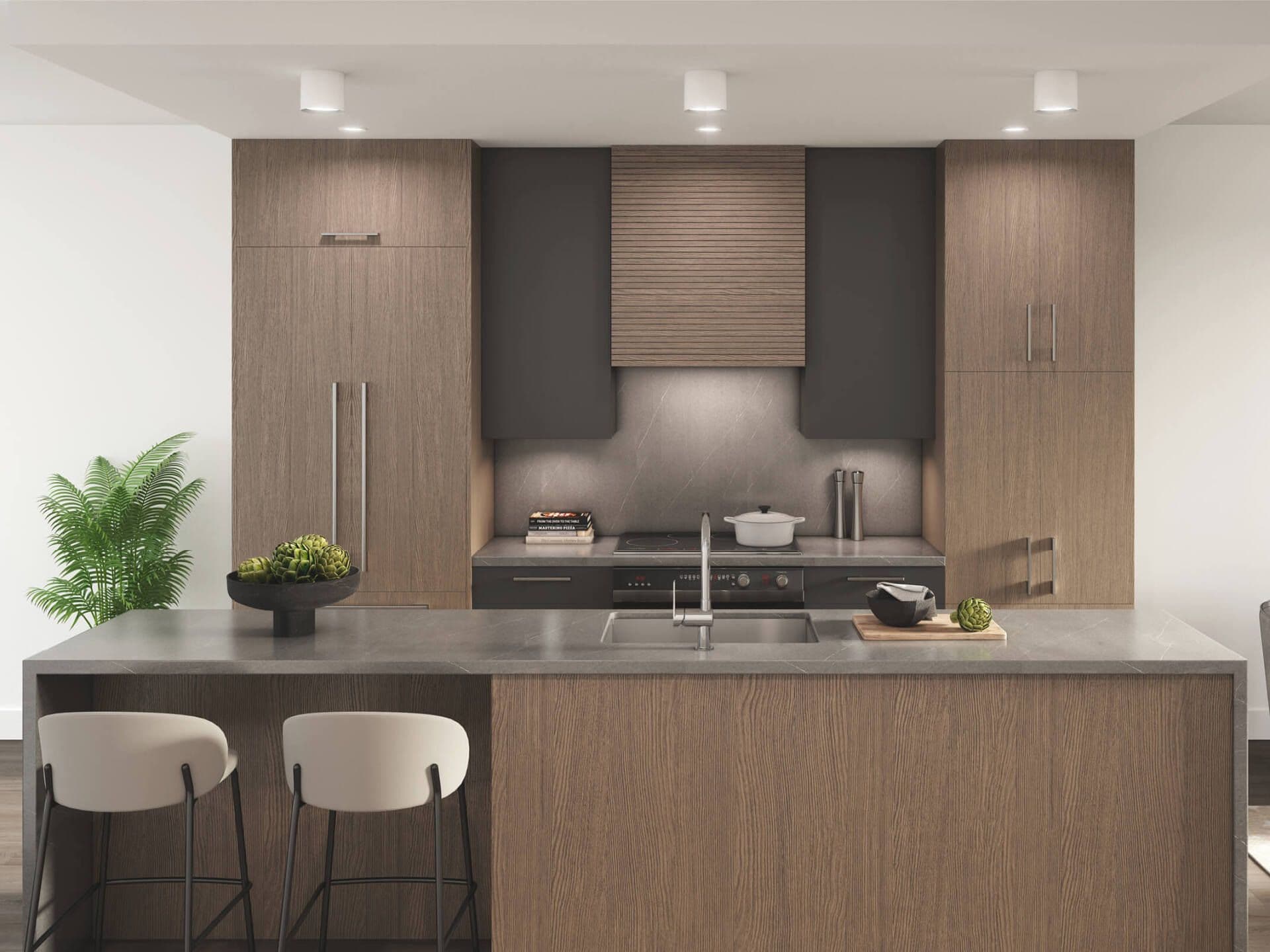 EIGHT – A kitchen with wood grain cabinetry, a dark stone hood surround, an induction cooktop, and a waterfall-edge island with two bar stools.