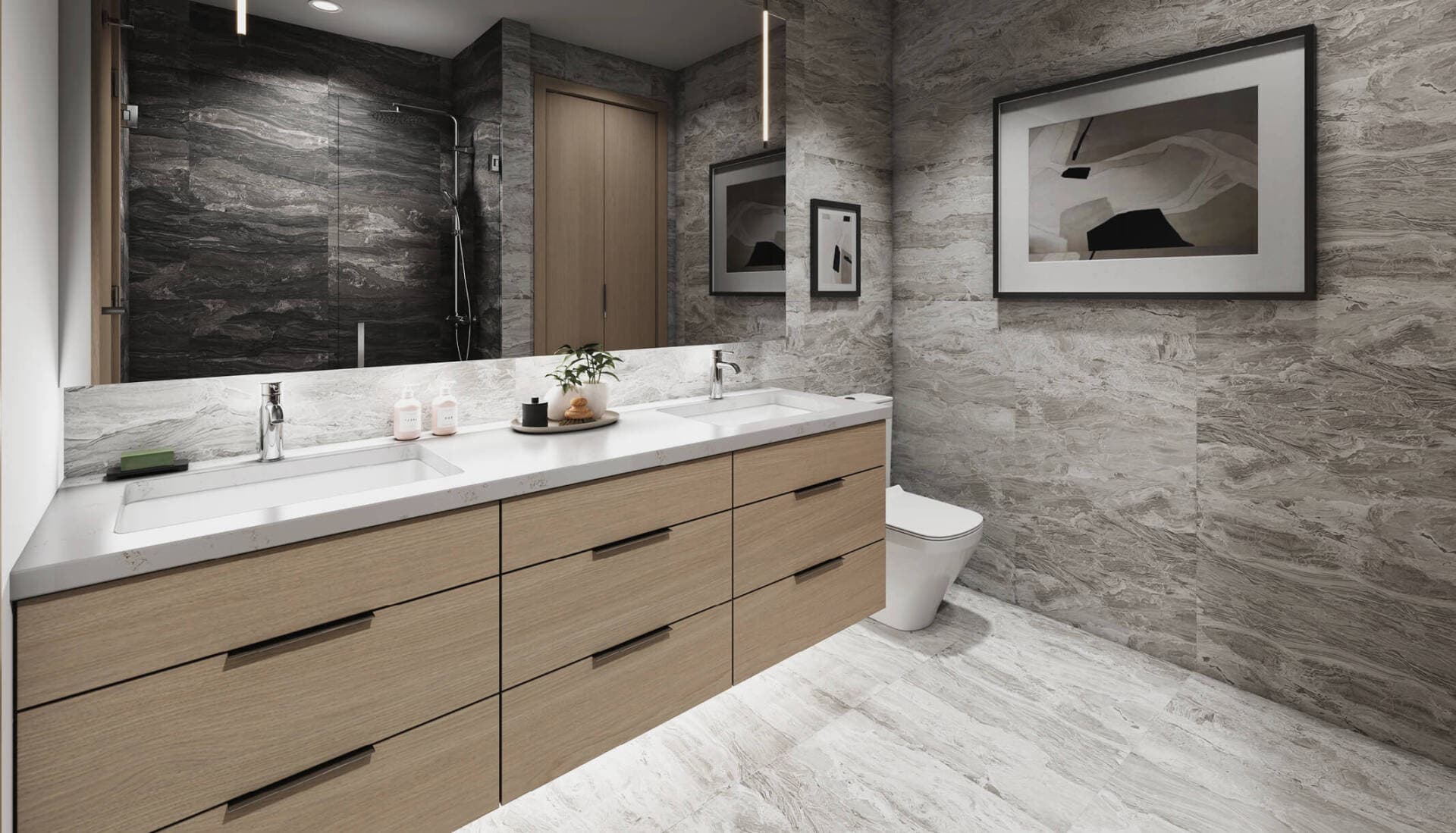 EIGHT – A bathroom with a double vanity, framed artwork, a glass-enclosed walk-in shower with dark stone tile, and a freestanding toilet.