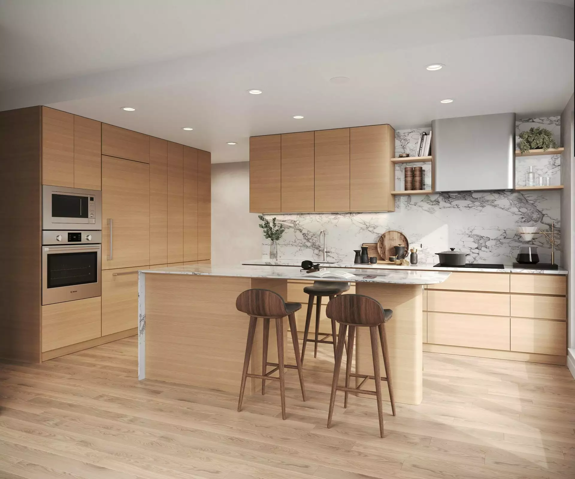 Edge Way at leləm̓ – A modern, sunlit kitchen featuring light wood flat-panel cabinetry, integrated wall ovens, and matching light hardwood floors. A central kitchen island with a marble countertop is paired with three wooden barstools, set against a full-height white marble backsplash with grey veining.