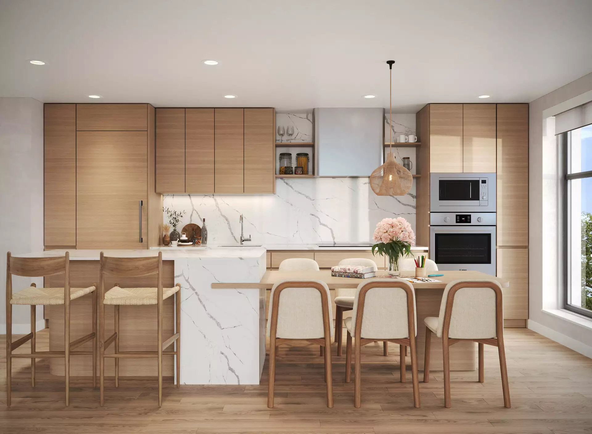 Edge Way at leləm̓ – A modern, sunlit kitchen featuring light wood flat-panel cabinetry, integrated stainless steel appliances, and a dramatic white marble backsplash and waterfall island. An attached wooden dining table with upholstered chairs extends from the island, complemented by woven barstools and a woven pendant light overhead.