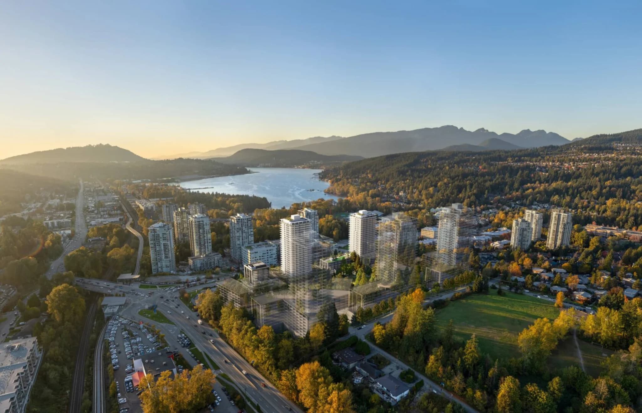 Inlet District – Aerial drone photo with a wireframe massing overlay showing proposed towers rising near an inlet, surrounded by mountains, trees, and existing highrises.