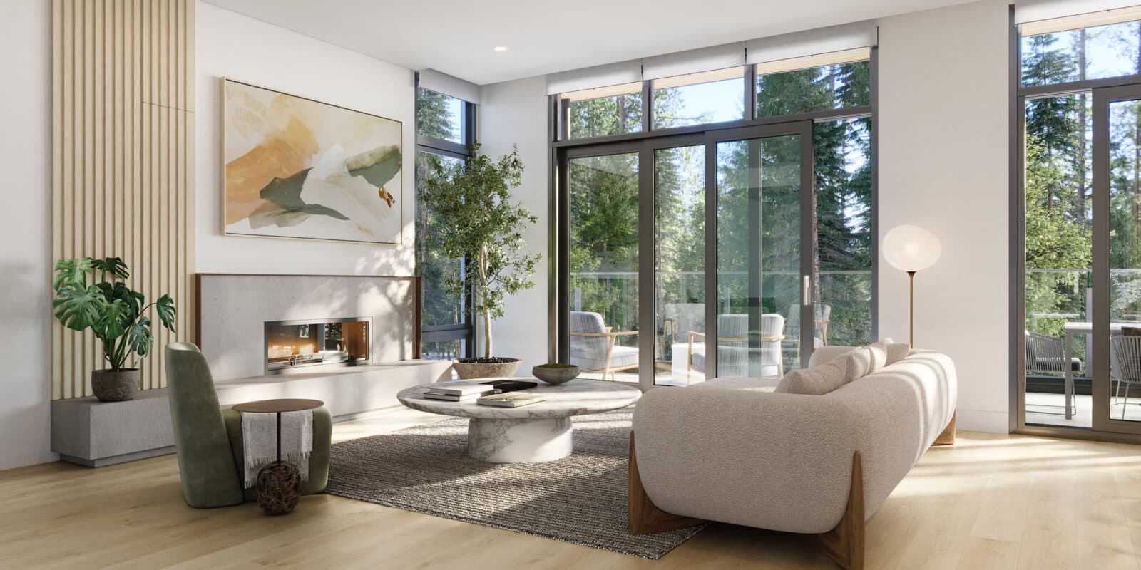 Wildwood at Uplands – Living room with a concrete fireplace, wall-mounted art, a large potted plant, and floor-to-ceiling sliding glass doors opening to a forested view.
