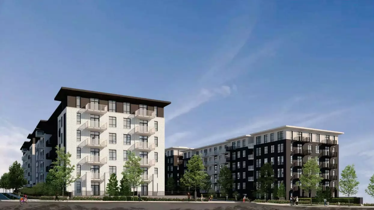 Grayson – A ground-level street perspective of a modern mid-rise residential complex featuring contrasting light white brick and dark gray panel exteriors. The buildings are framed by small trees, sidewalks with pedestrians, and a clear blue sky on a bright, sunny day.