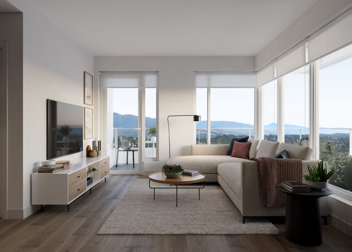 Band Condos – Living room with a beige sectional sofa, round coffee table, wall-mounted TV, and floor-to-ceiling windows showing a mountain view.