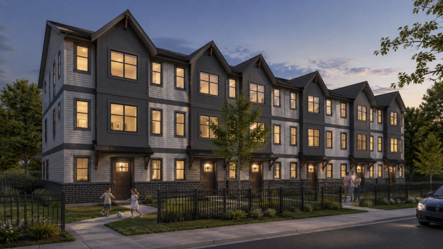 Cedar Village – Twilight street-level rendering of the townhome row with lit windows and children playing on the front lawn.