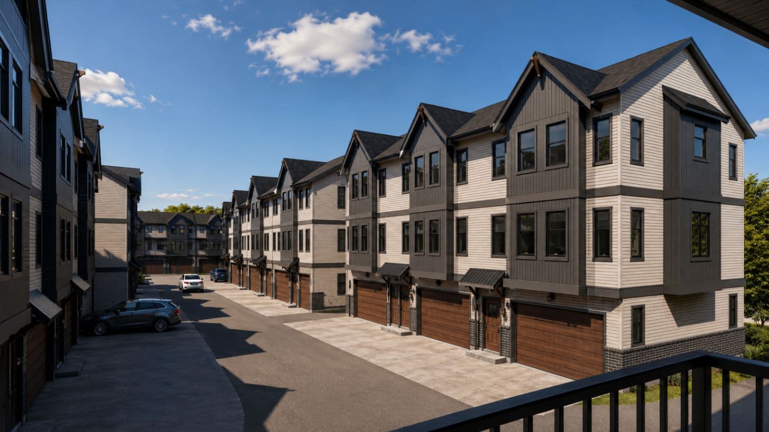 Cedar Village – Daytime rendering of the rear laneway showing garage doors and parked cars along the townhome complex.
