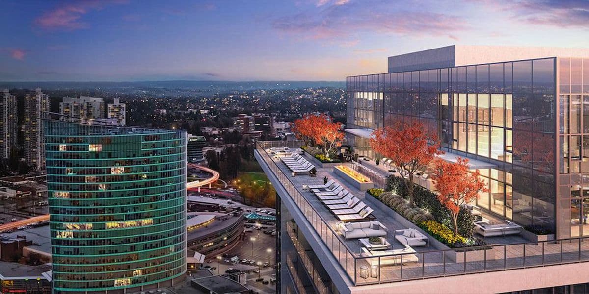 One Central – Rooftop terrace at dusk with lounge chairs, a fire feature, and seating areas overlooking the city skyline.