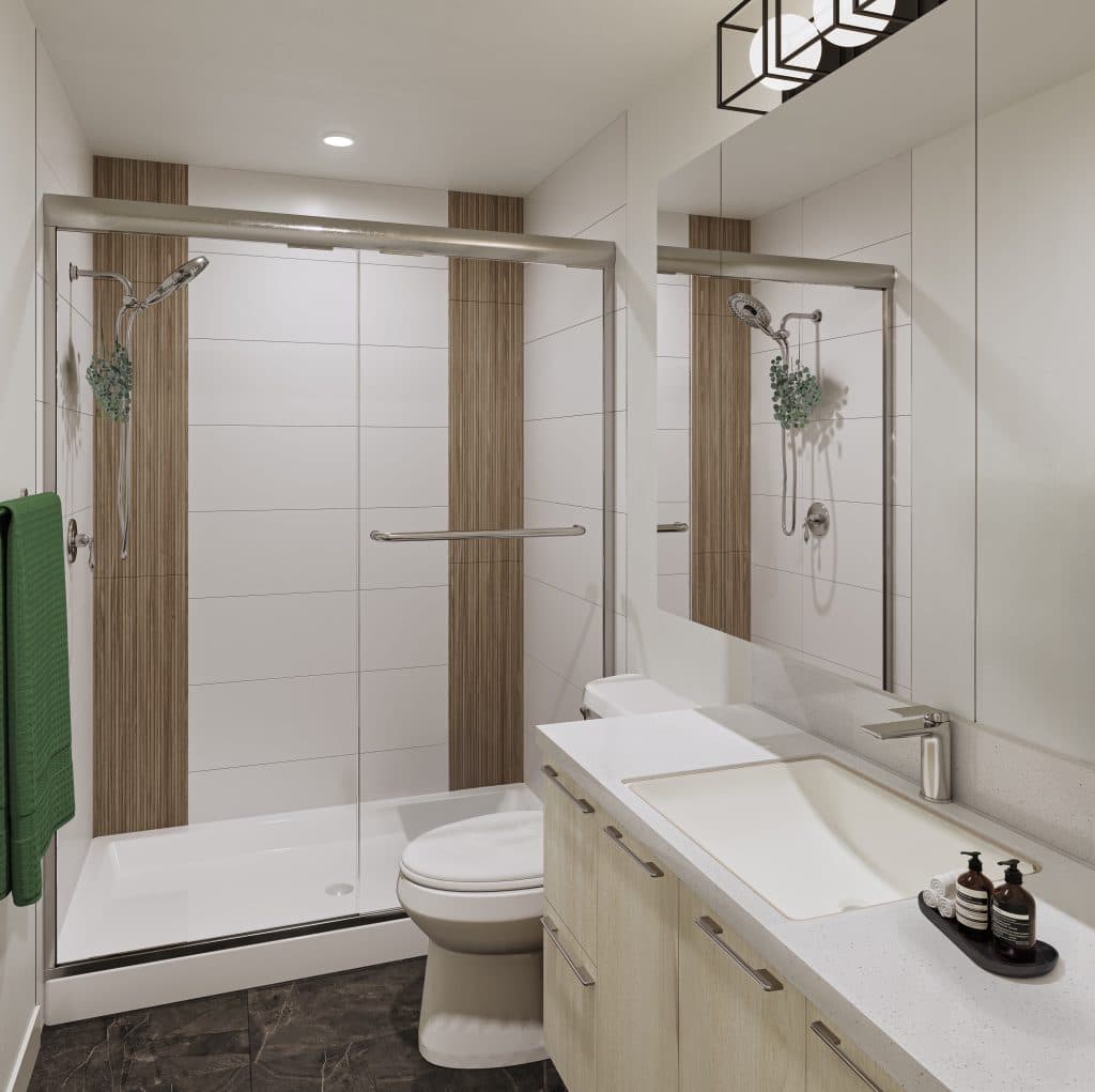 Interchange – Bathroom rendering with a glass-enclosed shower with wood-tone accent tile, a toilet, and a light wood vanity with white countertop.